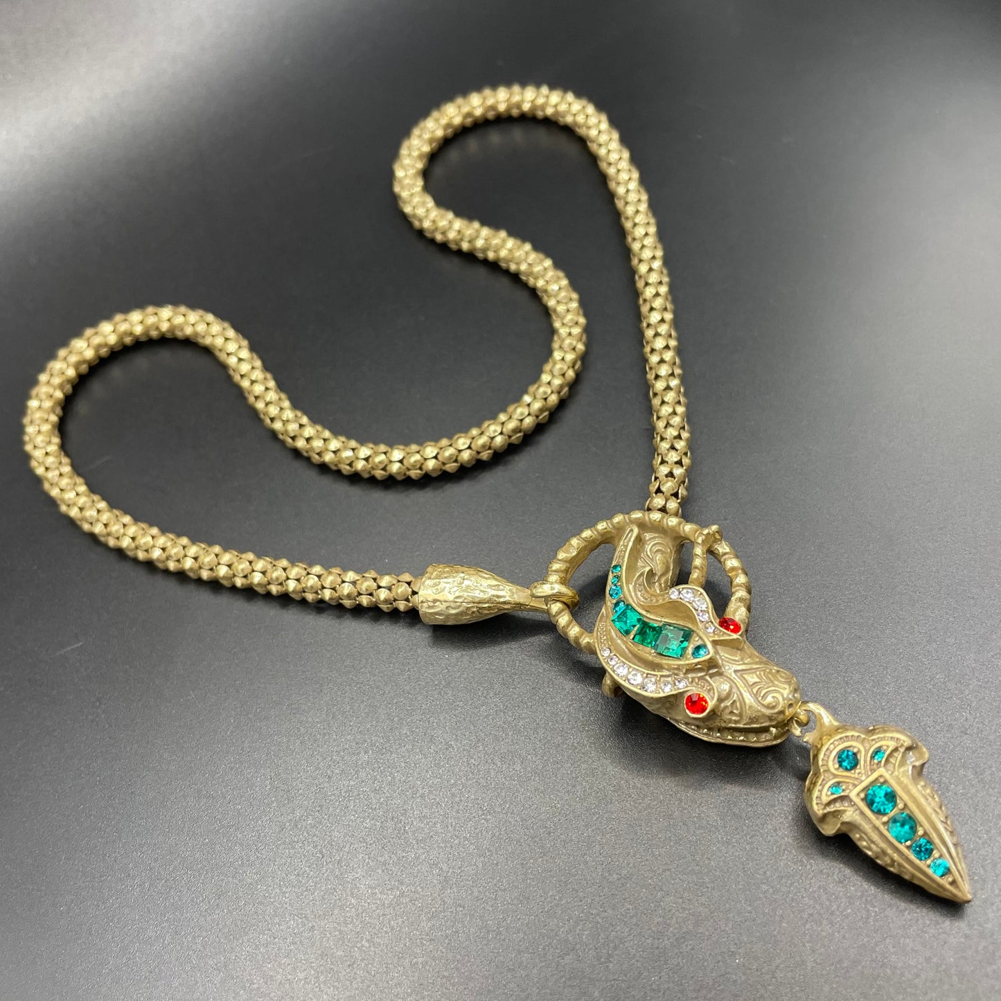 Vintage costume copy of opulent Victorian snake, serpent or dragon design lariat necklace, gold tone with red, green and clear rhinestones