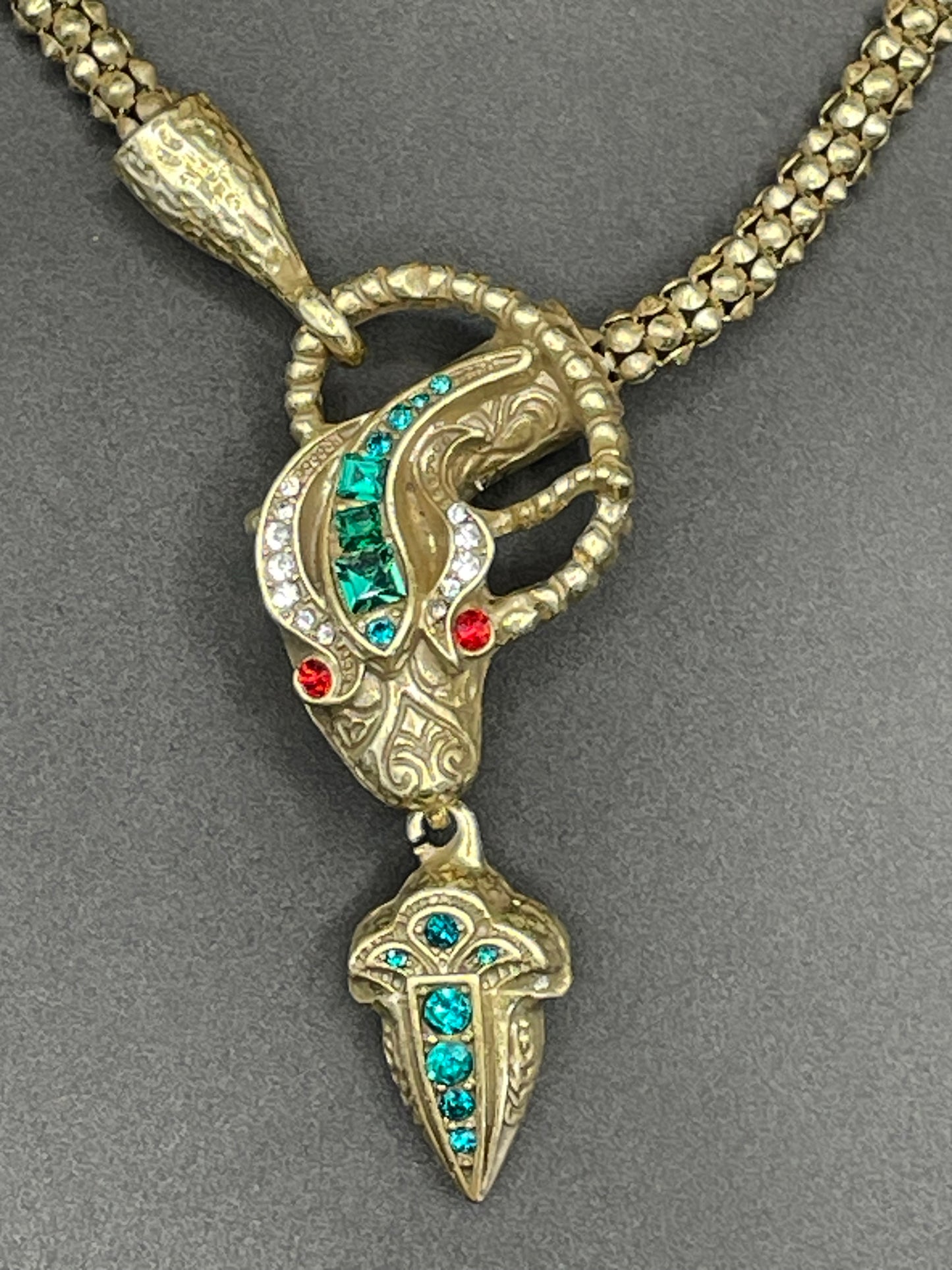 Vintage costume copy of opulent Victorian snake, serpent or dragon design lariat necklace, gold tone with red, green and clear rhinestones