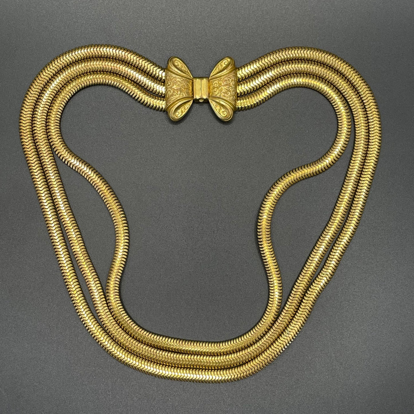 Vintage Art Deco machine age repousse bow clasp triple strand thick gold tone snake chain necklace