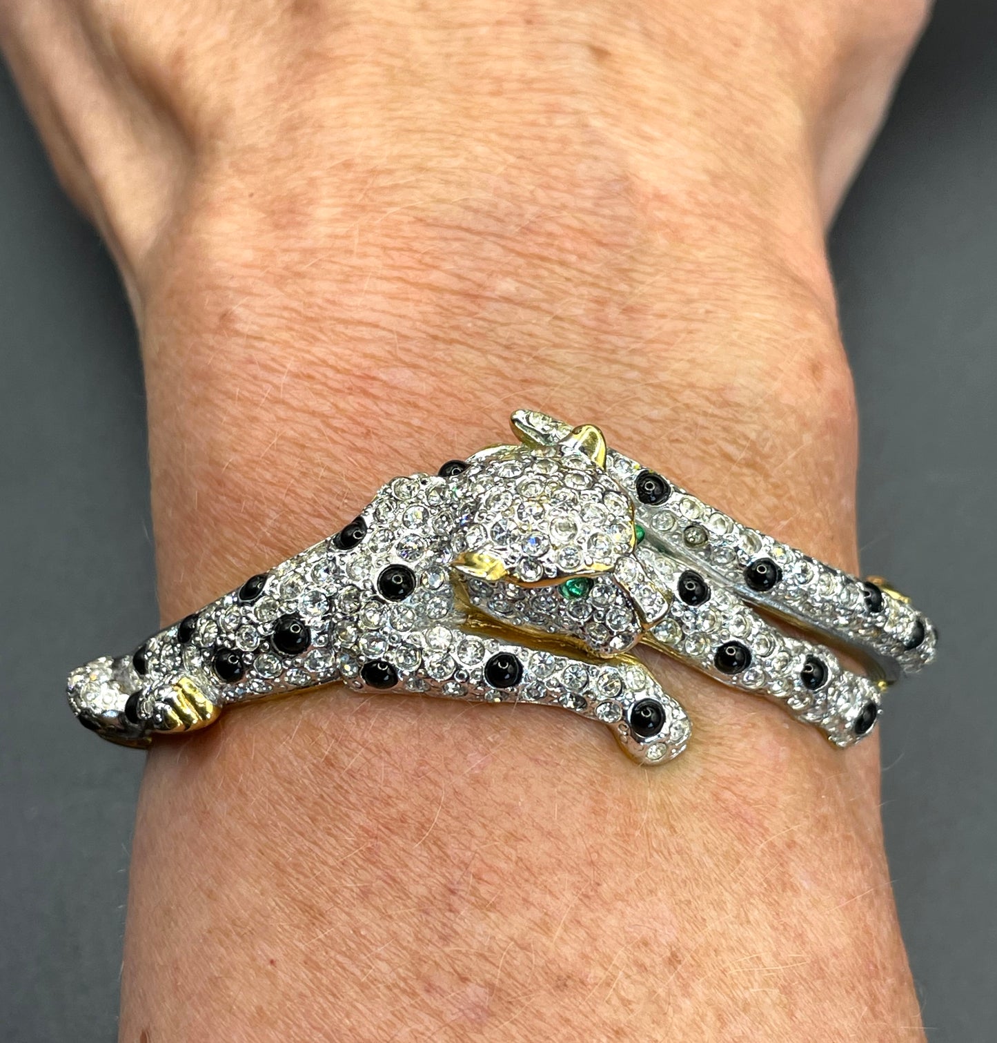 Vintage leopard / panther bangle, gold plated, green and black glass cabochons, clear rhinestones, interesting stamp signature