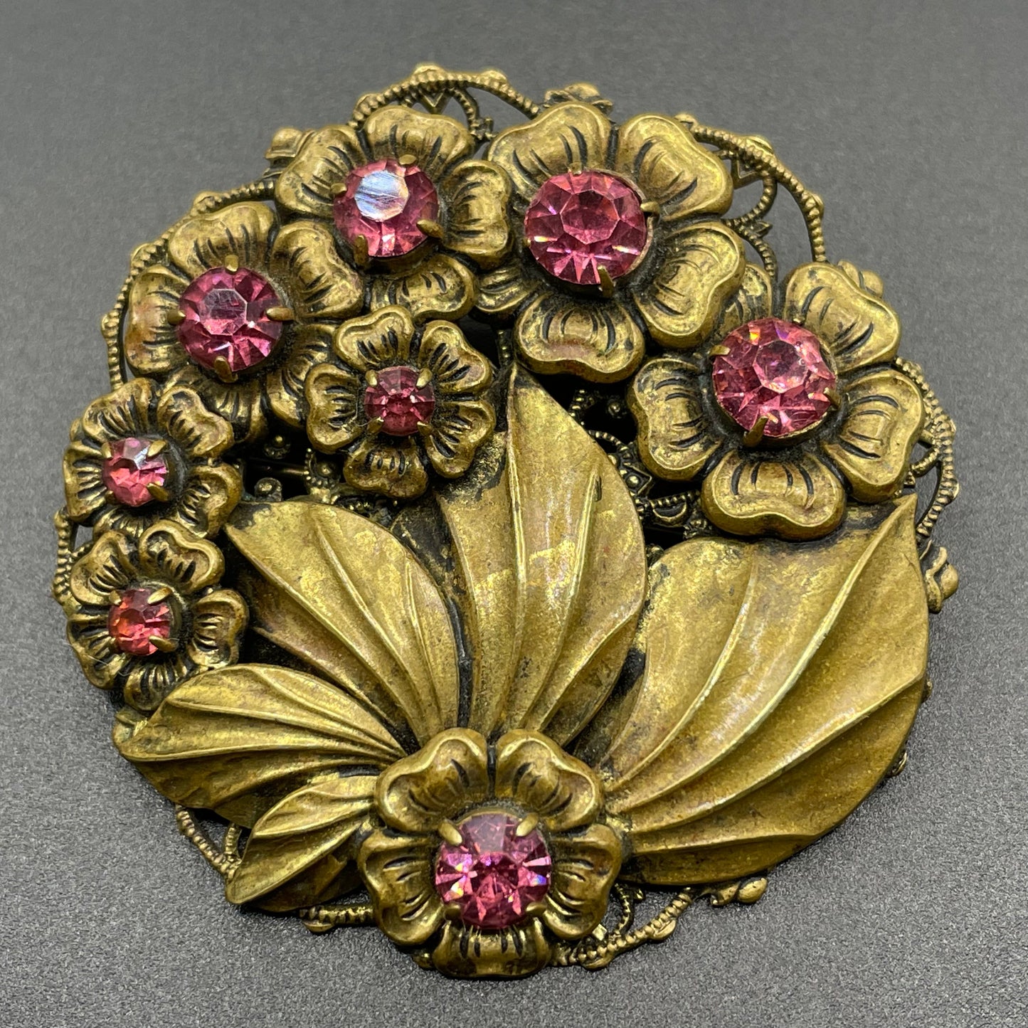 Vintage Art Deco Czech pink rhinestone brooch in a gorgeous gold tone floral and leaf design