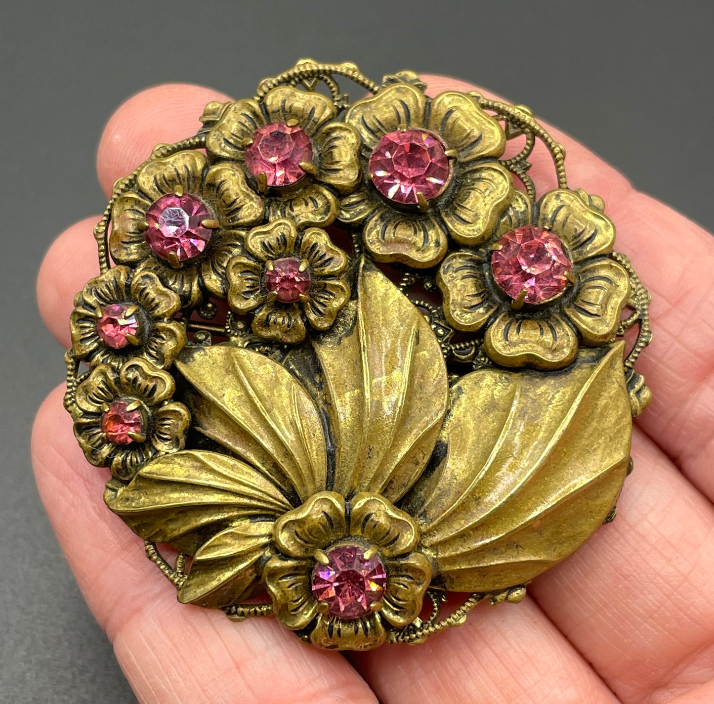 Vintage Art Deco Czech pink rhinestone brooch in a gorgeous gold tone floral and leaf design