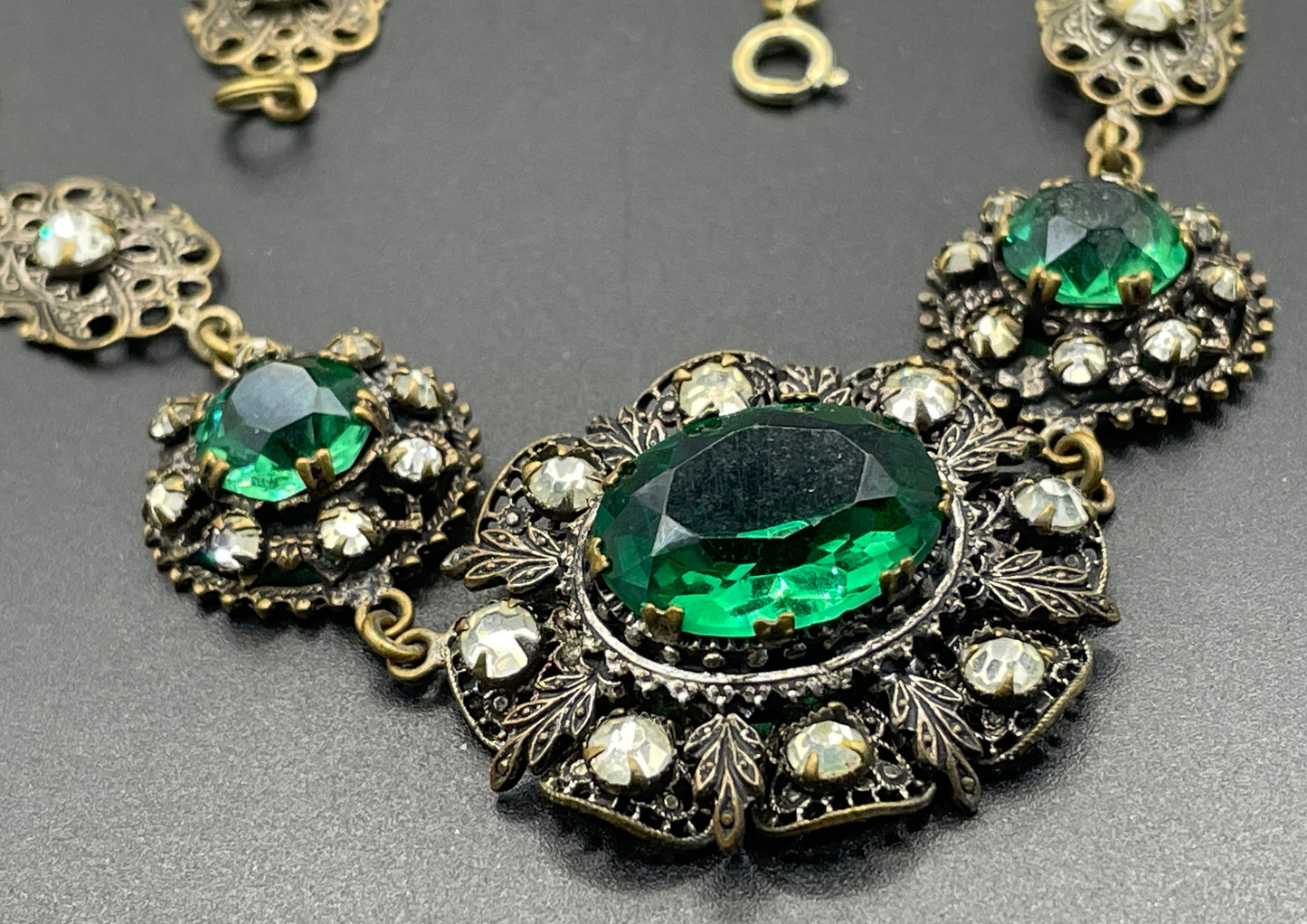 Vintage Art Deco Czech emerald green and clear glass rhinestone and gold tone filigree necklace, bracelet and brooch set, possibly Neiger