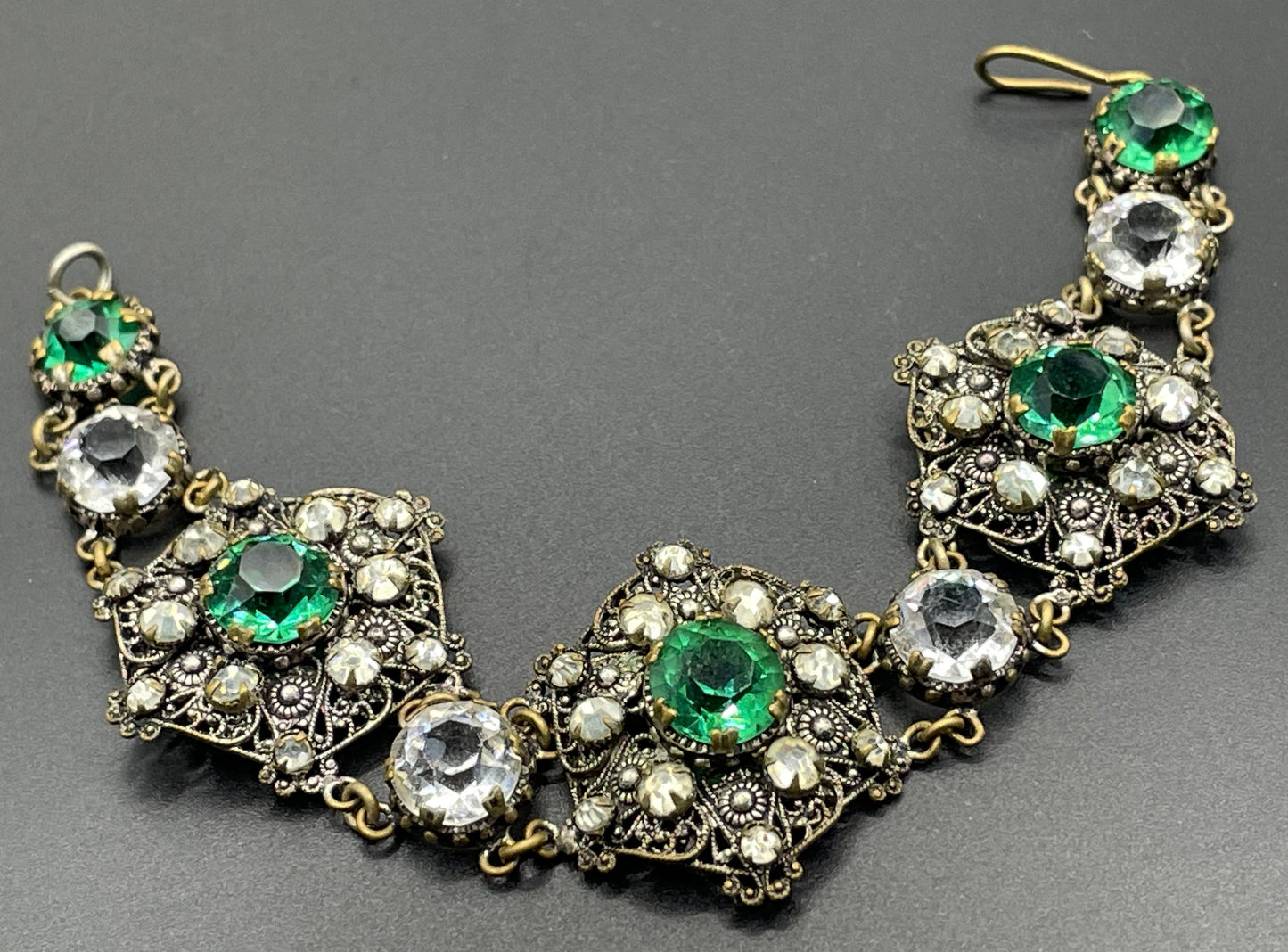 Vintage Art Deco Czech emerald green and clear glass rhinestone and gold tone filigree necklace, bracelet and brooch set, possibly Neiger