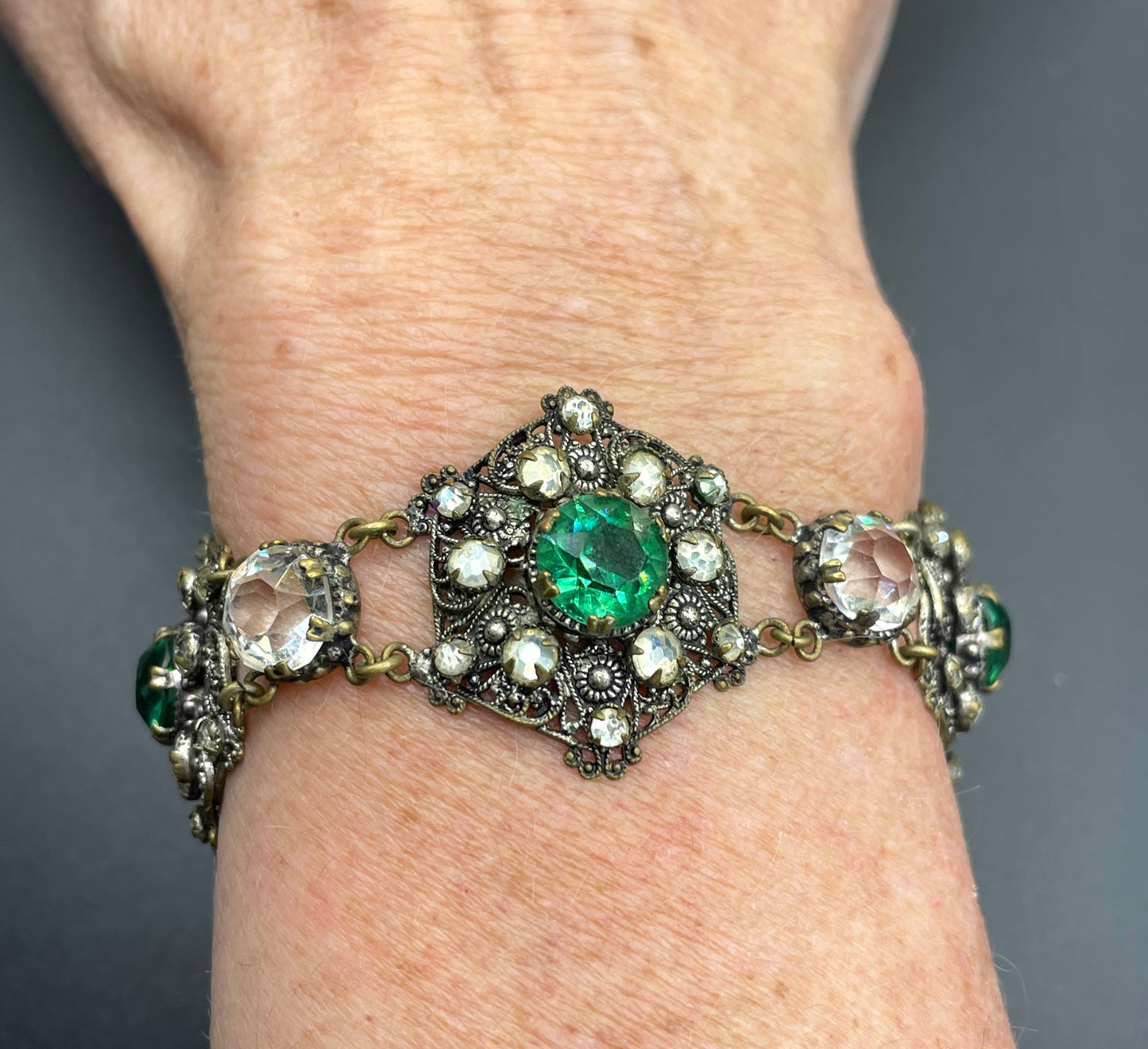 Vintage Art Deco Czech emerald green and clear glass rhinestone and gold tone filigree necklace, bracelet and brooch set, possibly Neiger