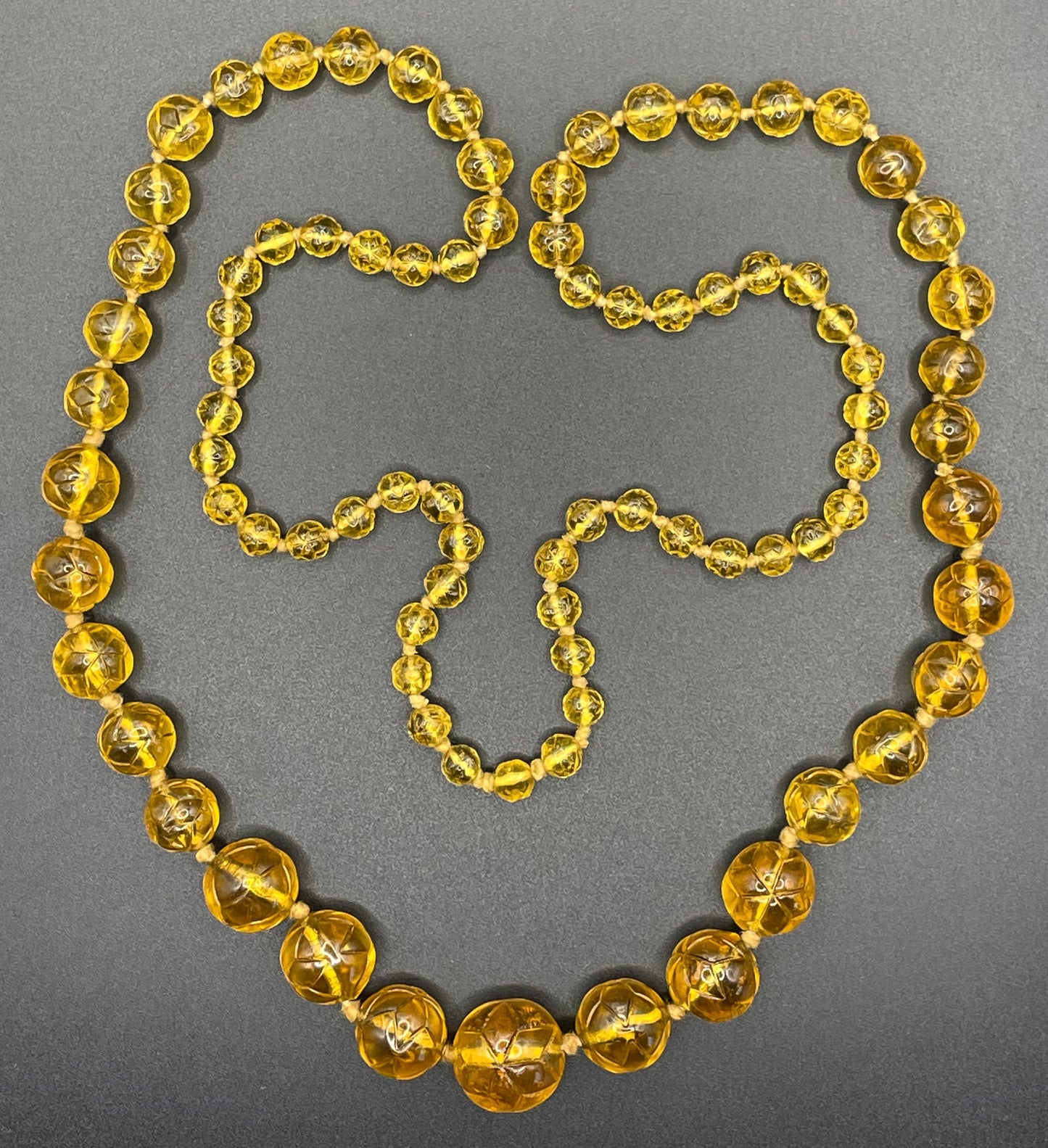 Vintage moulded pressed glass citrine yellow / orange graduated bead flapper necklace mid to longer length