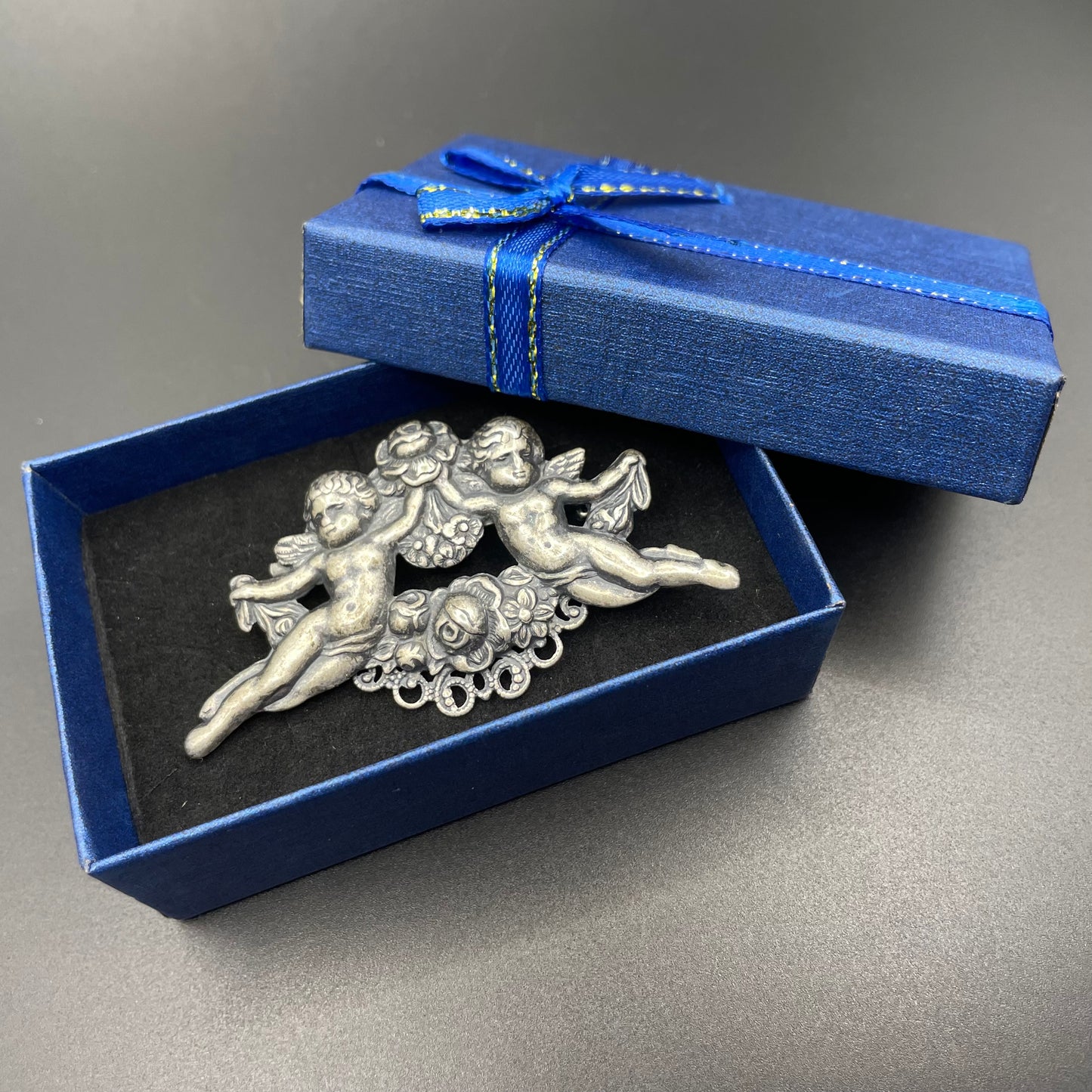 Possibly early Askew London, vintage cherub cupid floral brooch in antique silver tone