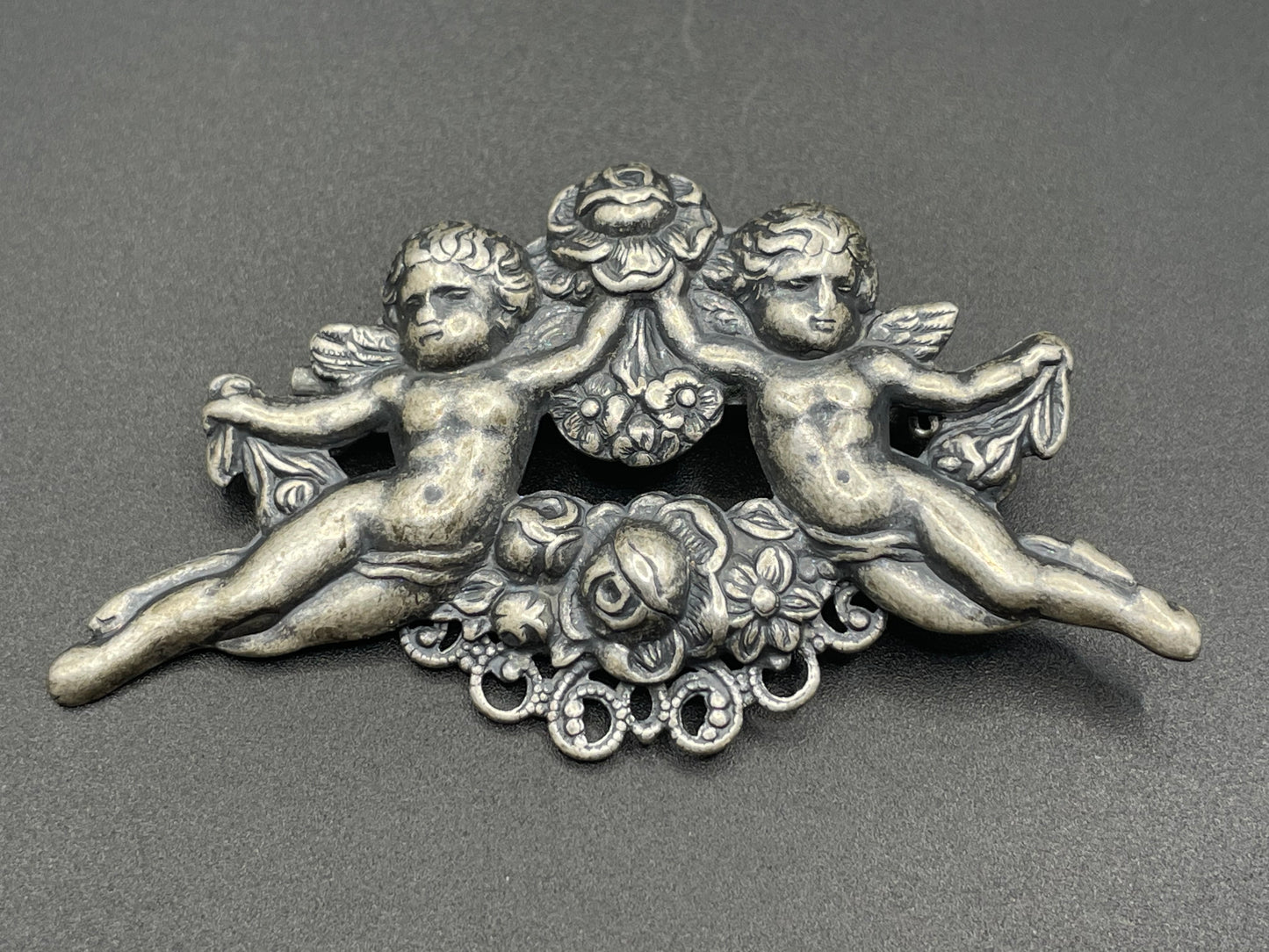 Possibly early Askew London, vintage cherub cupid floral brooch in antique silver tone