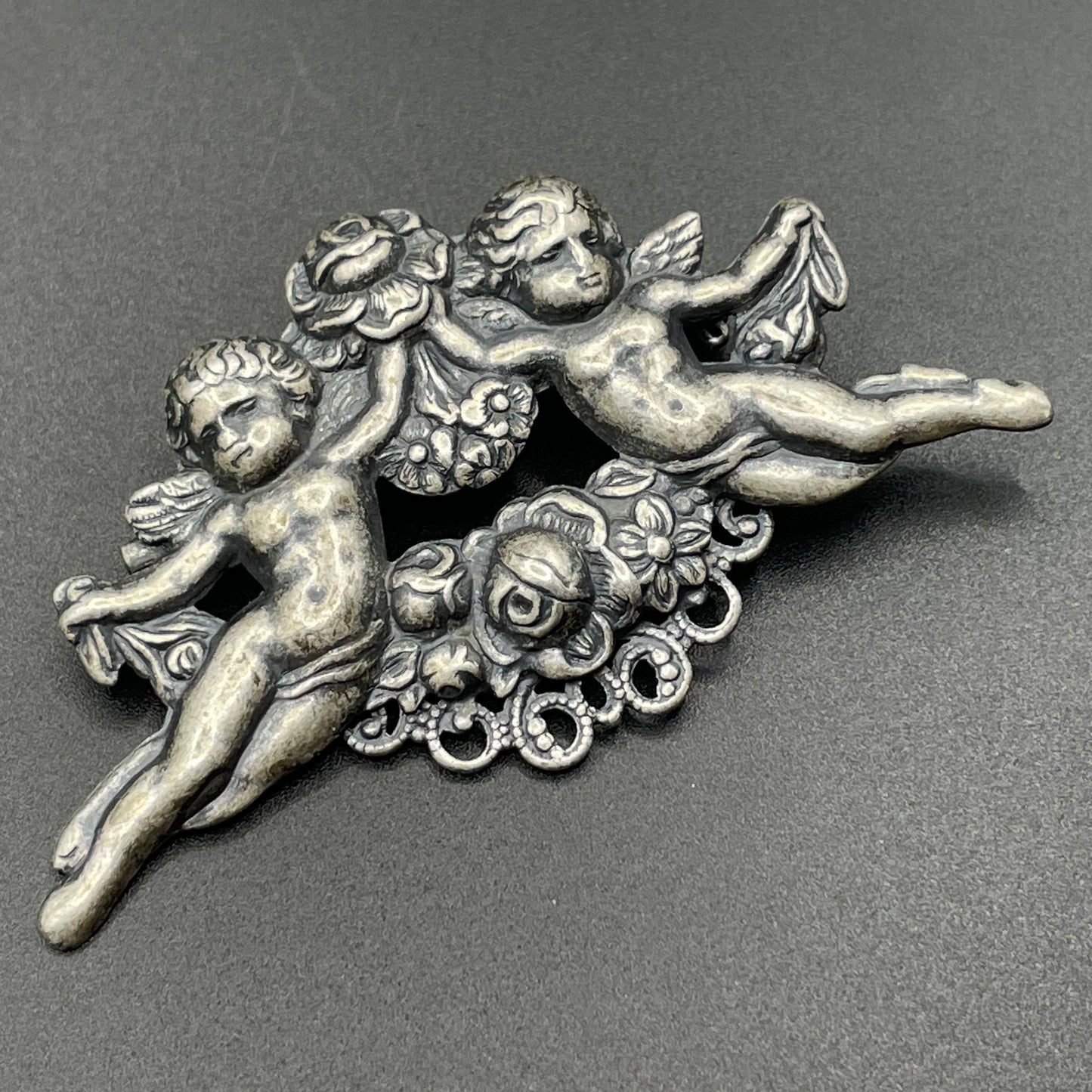 Possibly early Askew London, vintage cherub cupid floral brooch in antique silver tone
