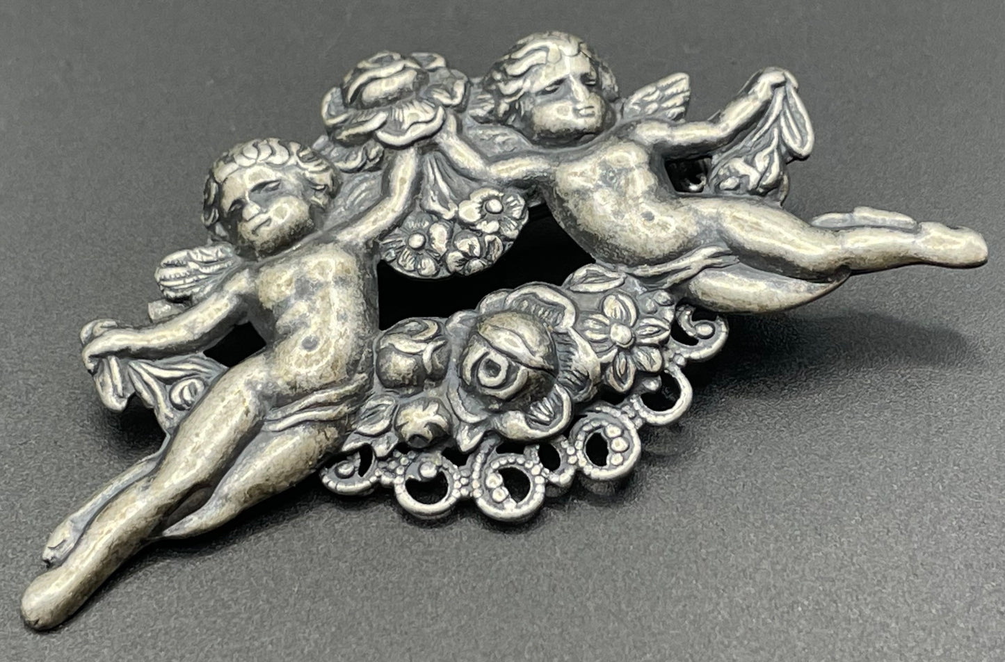 Possibly early Askew London, vintage cherub cupid floral brooch in antique silver tone