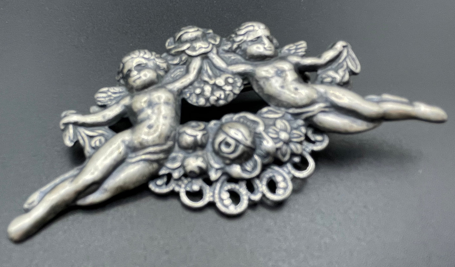 Possibly early Askew London, vintage cherub cupid floral brooch in antique silver tone
