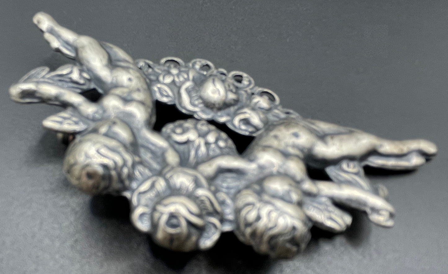 Possibly early Askew London, vintage cherub cupid floral brooch in antique silver tone