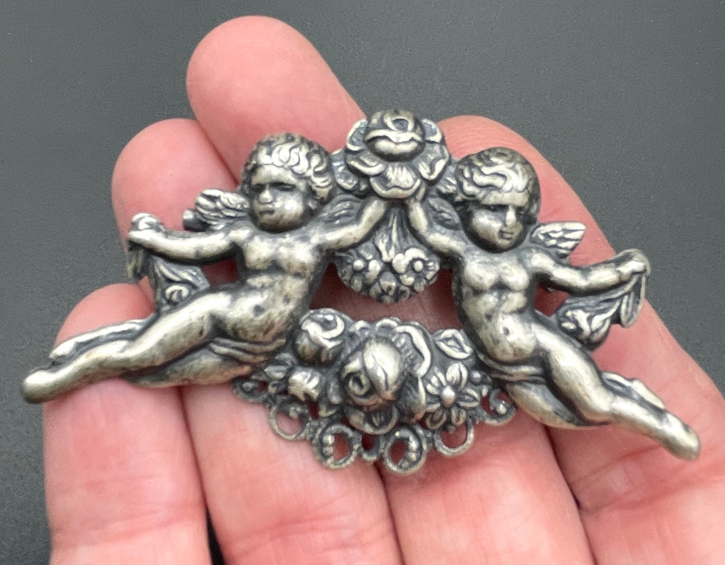 Possibly early Askew London, vintage cherub cupid floral brooch in antique silver tone