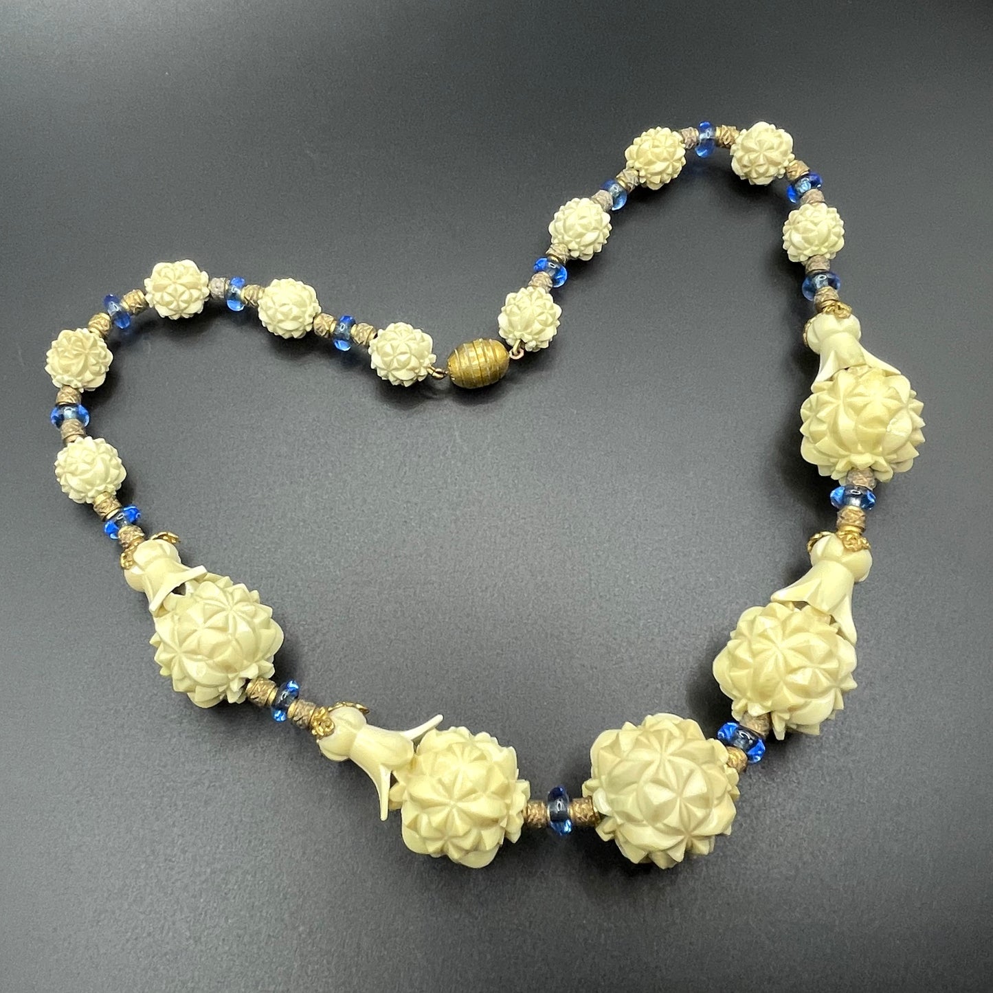 Vintage Louis Rousselet Art Deco carved cream galalith large bead necklace, beehive clasp marked 'Made in France', foxtail chain, blue glass