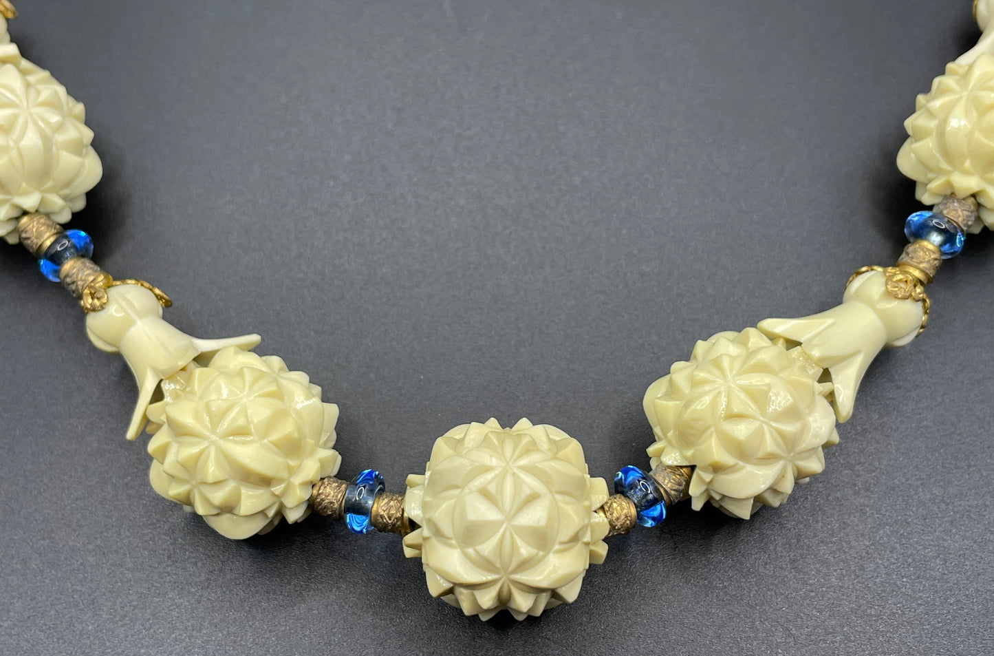 Vintage Louis Rousselet Art Deco carved cream galalith large bead necklace, beehive clasp marked 'Made in France', foxtail chain, blue glass
