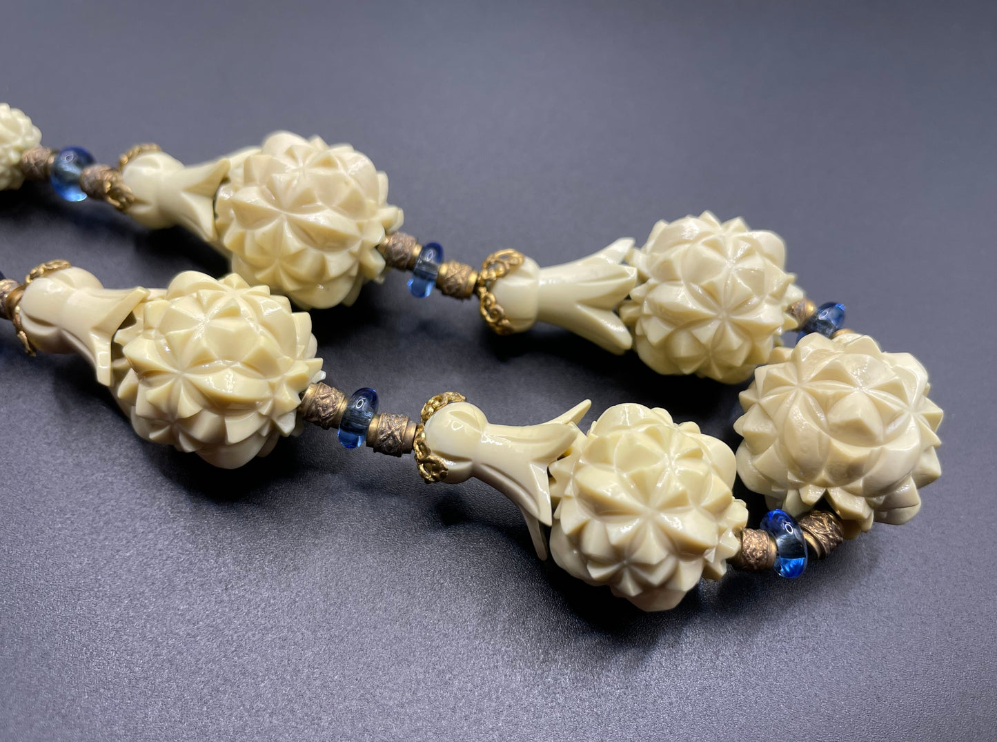 Vintage Louis Rousselet Art Deco carved cream galalith large bead necklace, beehive clasp marked 'Made in France', foxtail chain, blue glass