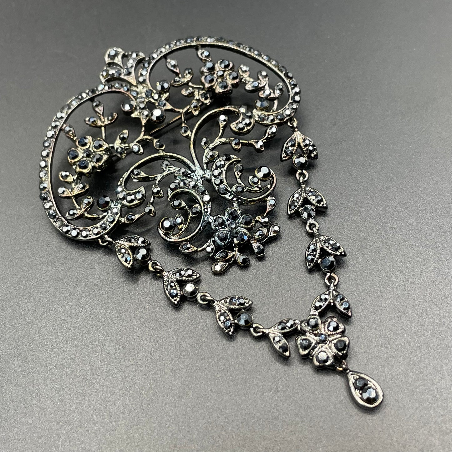 Large vintage Butler and Wilson (B&W) signed blackened silver tone and black French jet rhinestone ornate festoon 'stomacher' brooch