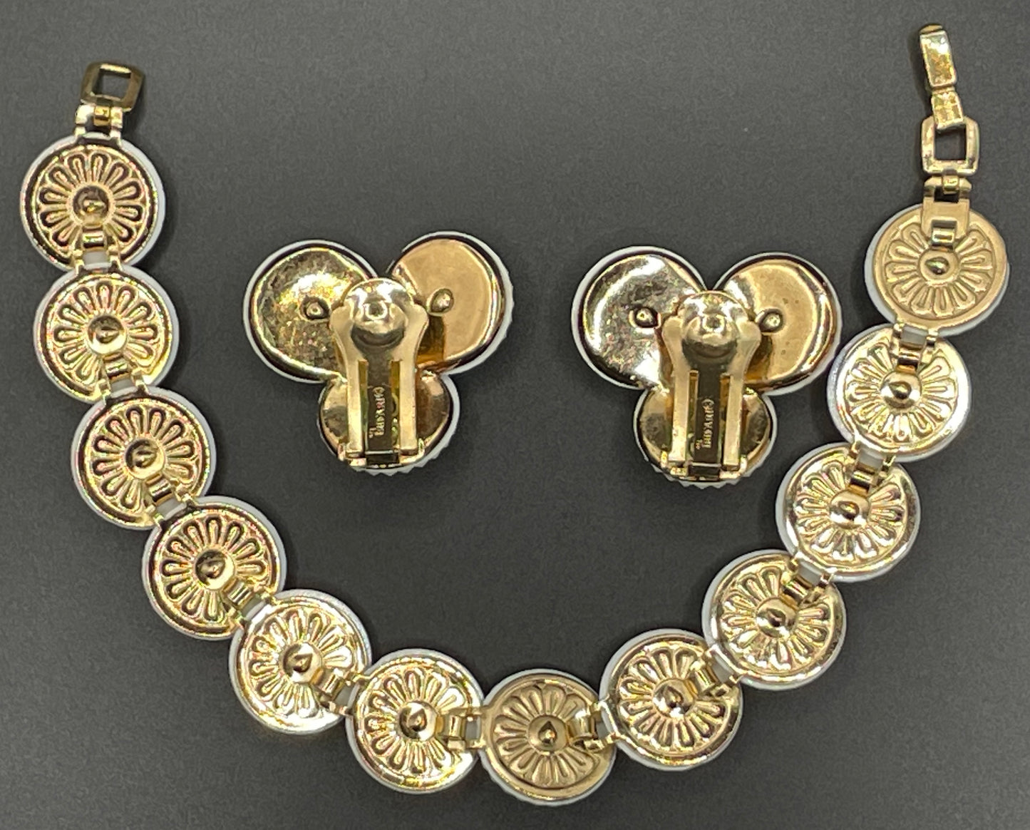 Vintage signed Trifari white celluloid plastic, clear rhinestone and gold tone panel bracelet and clip on earrings set, 1960s