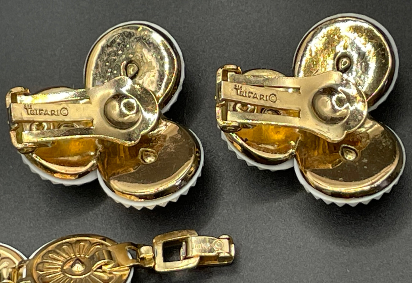 Vintage signed Trifari white celluloid plastic, clear rhinestone and gold tone panel bracelet and clip on earrings set, 1960s