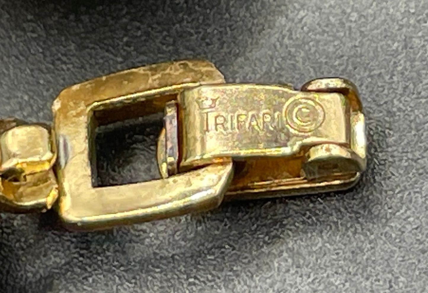 Vintage signed Trifari white celluloid plastic, clear rhinestone and gold tone panel bracelet and clip on earrings set, 1960s