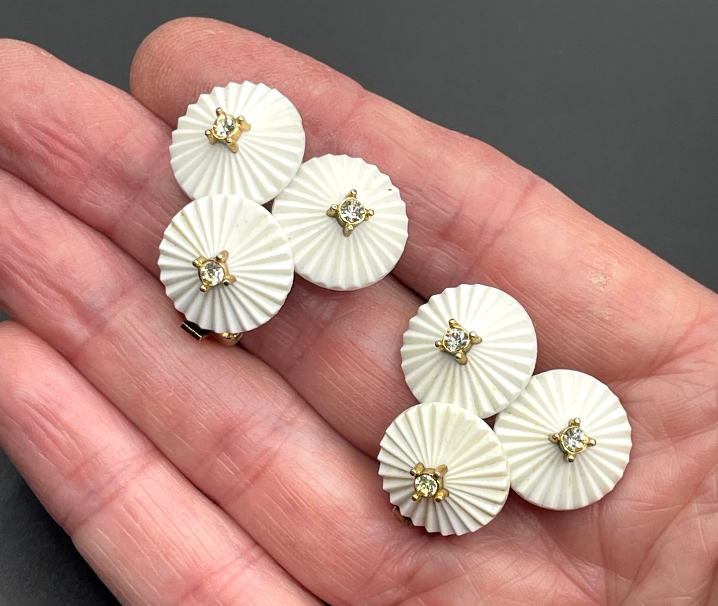 Vintage signed Trifari white celluloid plastic, clear rhinestone and gold tone panel bracelet and clip on earrings set, 1960s