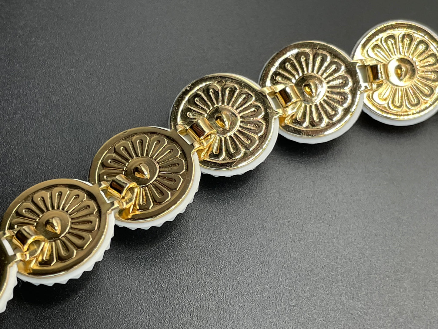 Vintage signed Trifari white celluloid plastic, clear rhinestone and gold tone panel bracelet and clip on earrings set, 1960s