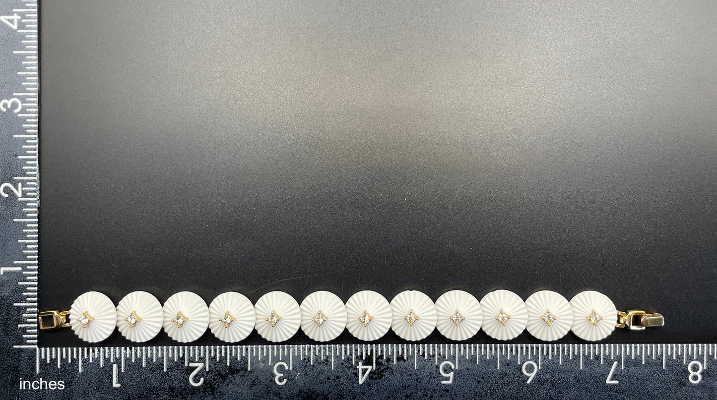 Vintage signed Trifari white celluloid plastic, clear rhinestone and gold tone panel bracelet and clip on earrings set, 1960s