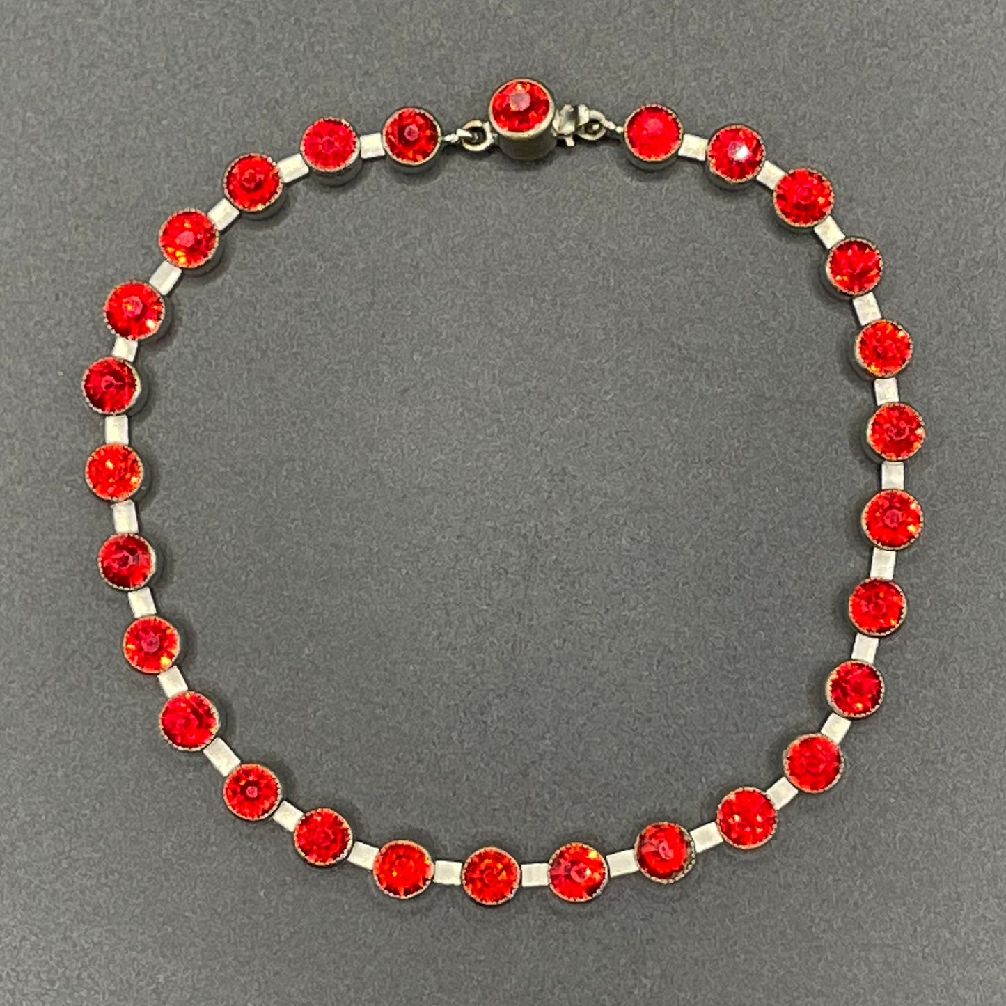 Vintage 1930s Art Deco collet set bright ruby red rhinestone and silver tone tennis / cocktail bracelet