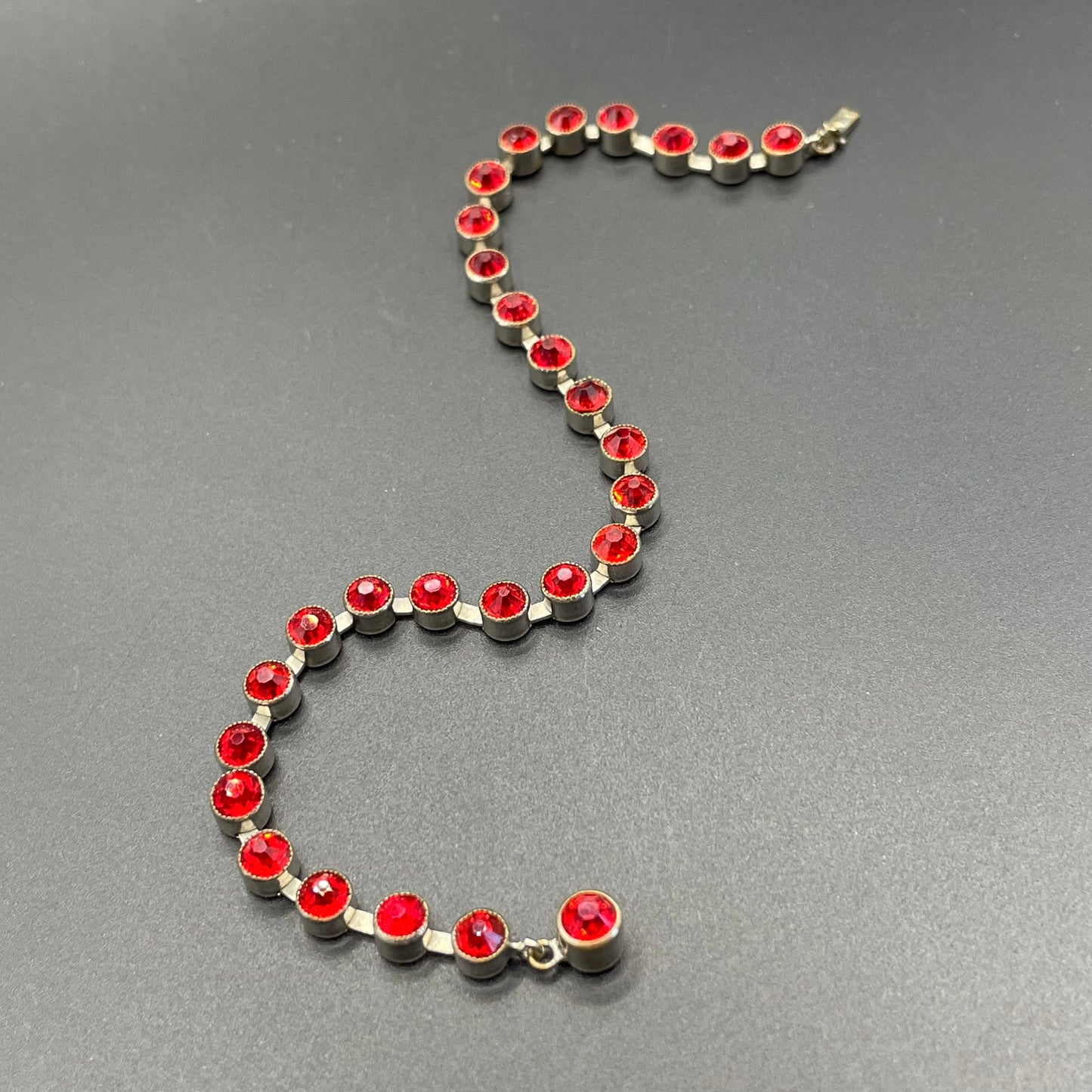 Vintage 1930s Art Deco collet set bright ruby red rhinestone and silver tone tennis / cocktail bracelet