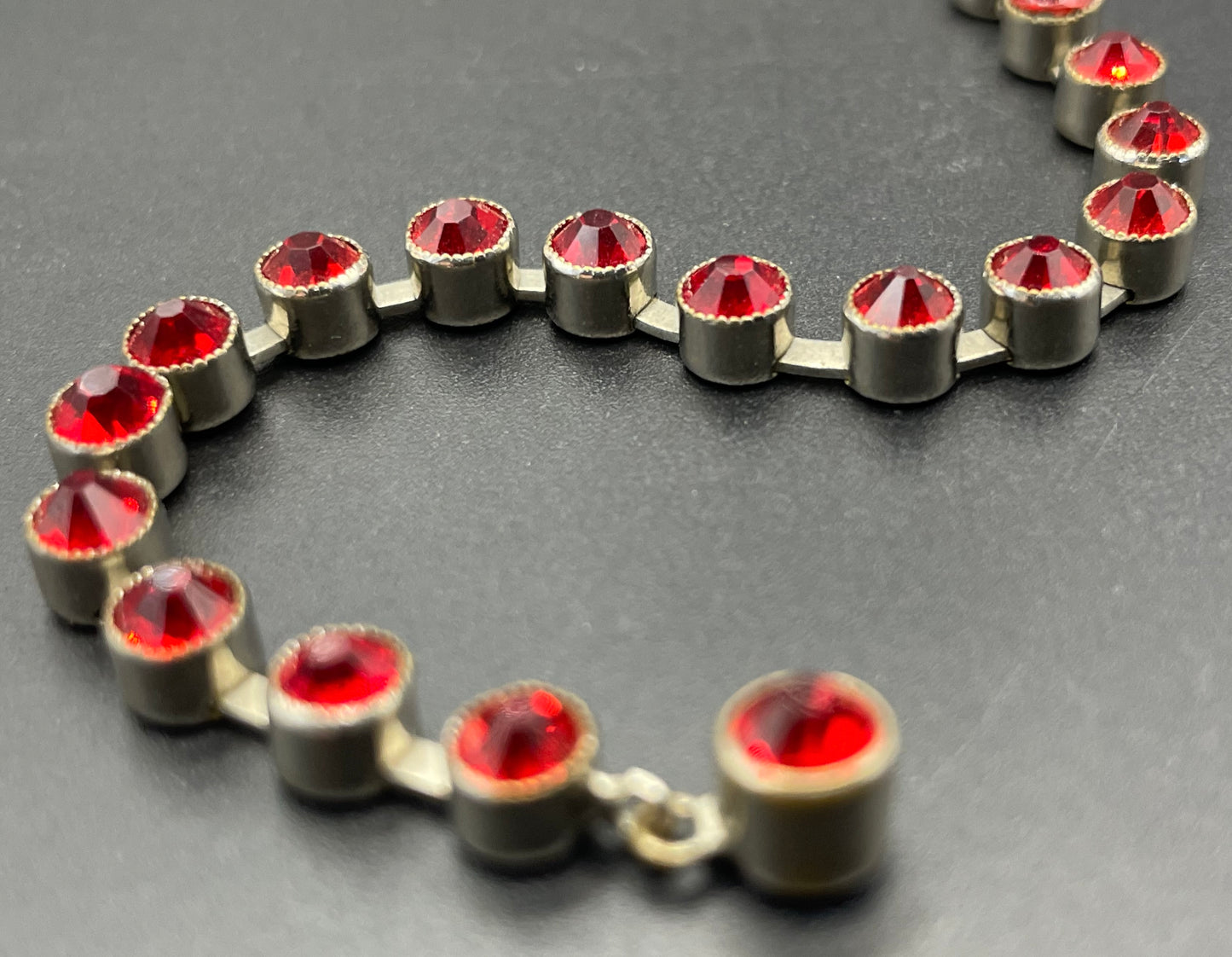 Vintage 1930s Art Deco collet set bright ruby red rhinestone and silver tone tennis / cocktail bracelet