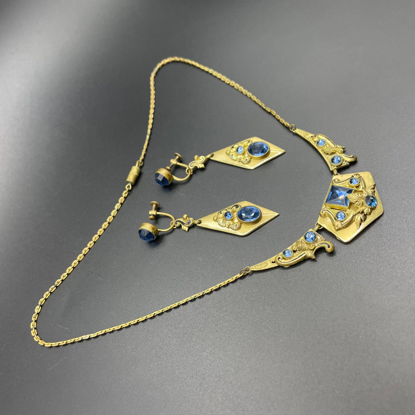 Vintage Neiger brothers sapphire blue rhinestone ornate Art Deco necklace and screw back earrings set in gold tone