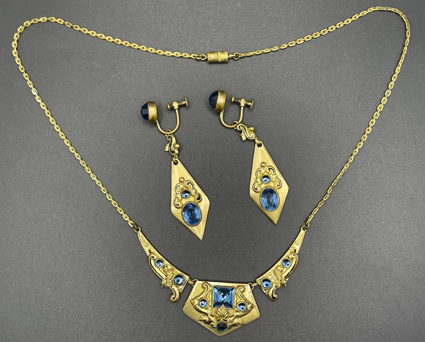 Vintage Neiger brothers sapphire blue rhinestone ornate Art Deco necklace and screw back earrings set in gold tone