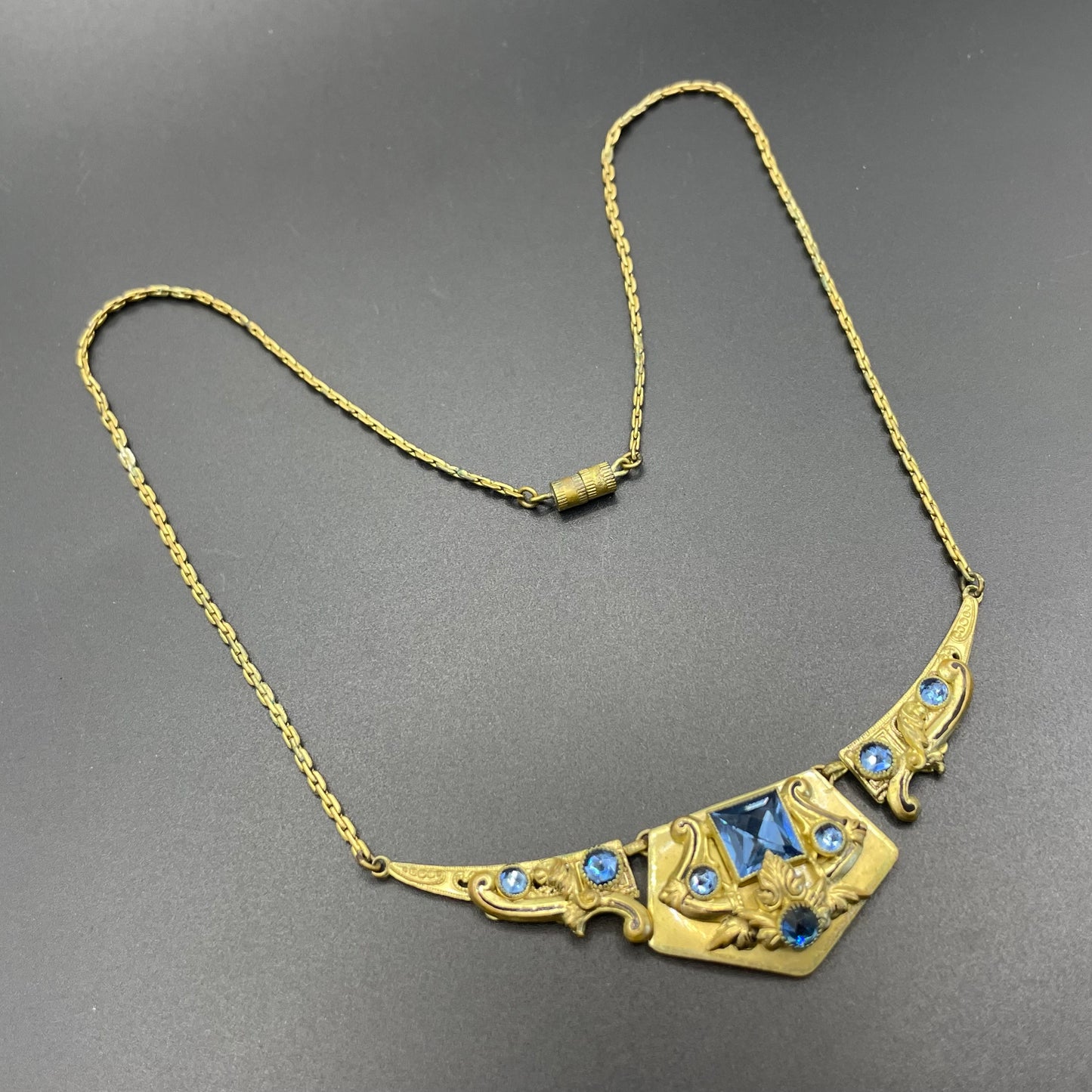 Vintage Neiger brothers sapphire blue rhinestone ornate Art Deco necklace and screw back earrings set in gold tone