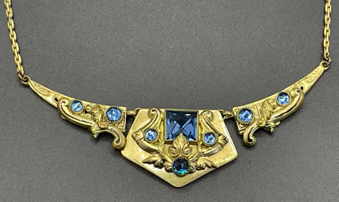 Vintage Neiger brothers sapphire blue rhinestone ornate Art Deco necklace and screw back earrings set in gold tone