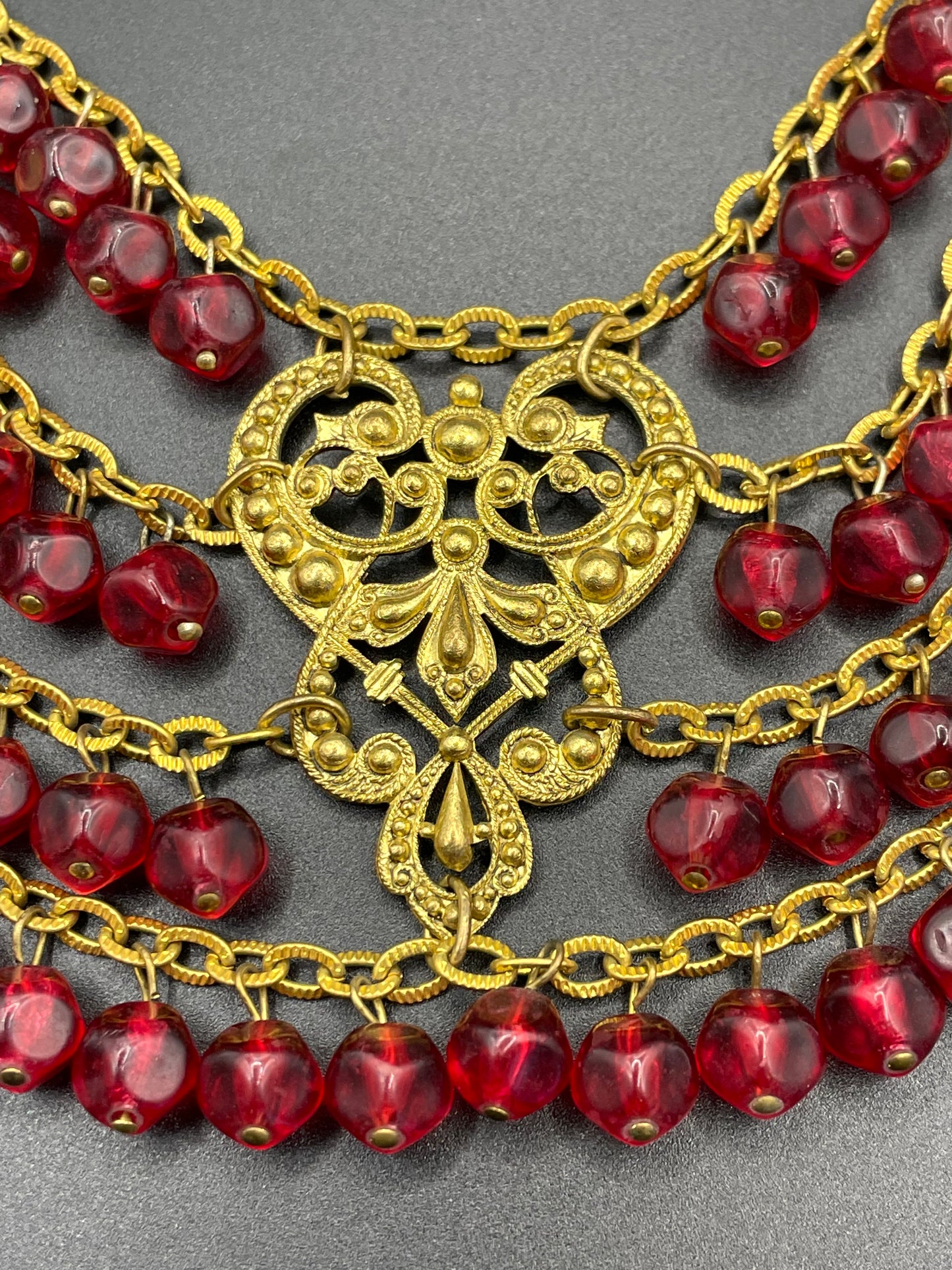 Vintage ruby red poured glass beaded festoon fringe necklace with gold tone filigree panels, French or Czech or perhaps Miriam Haskell style