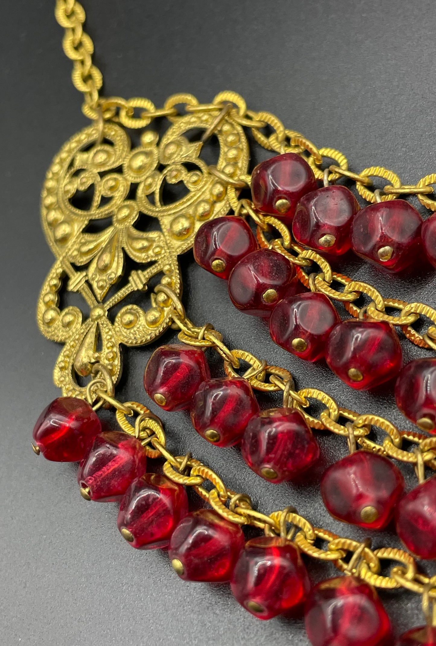 Vintage ruby red poured glass beaded festoon fringe necklace with gold tone filigree panels, French or Czech or perhaps Miriam Haskell style
