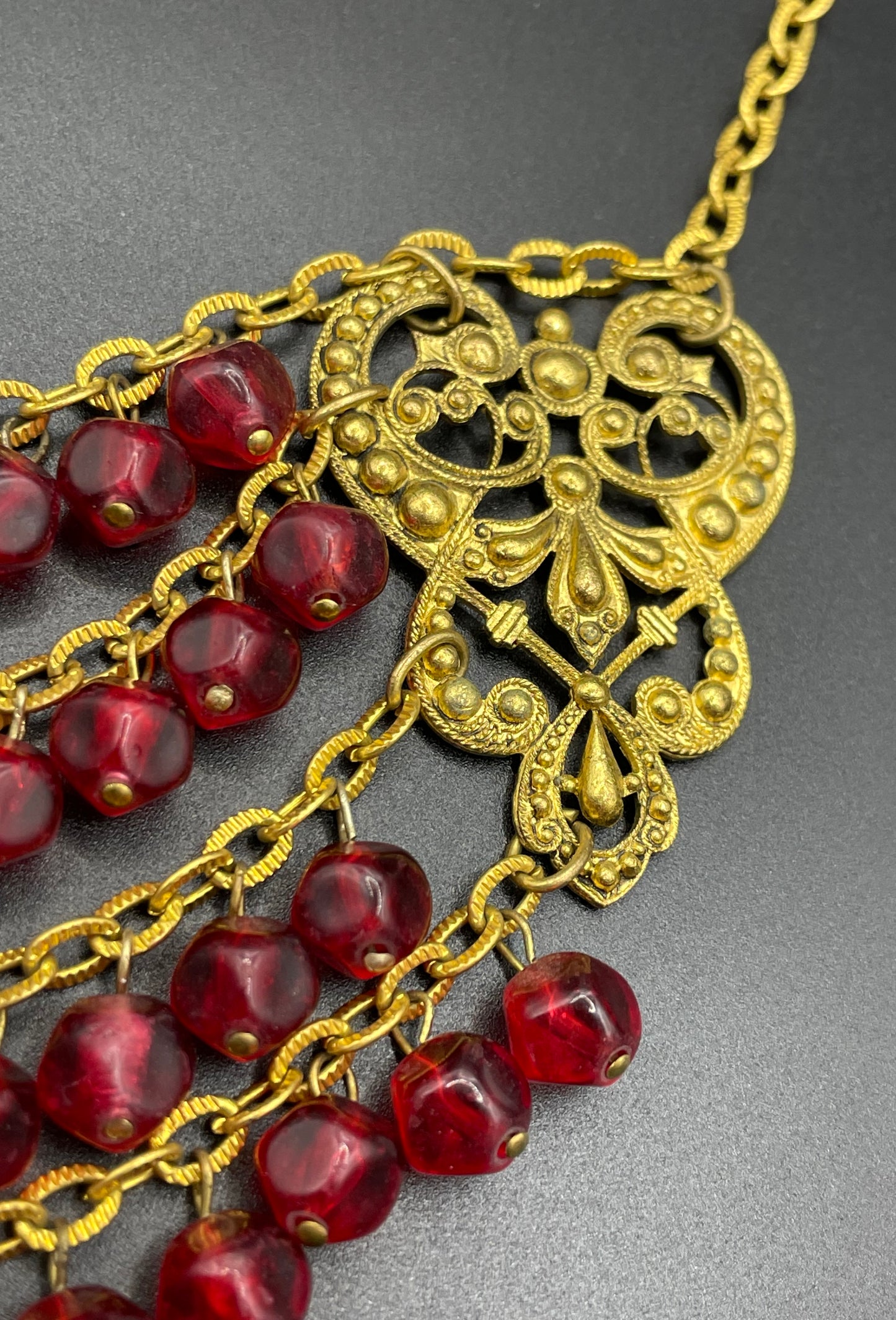 Vintage ruby red poured glass beaded festoon fringe necklace with gold tone filigree panels, French or Czech or perhaps Miriam Haskell style
