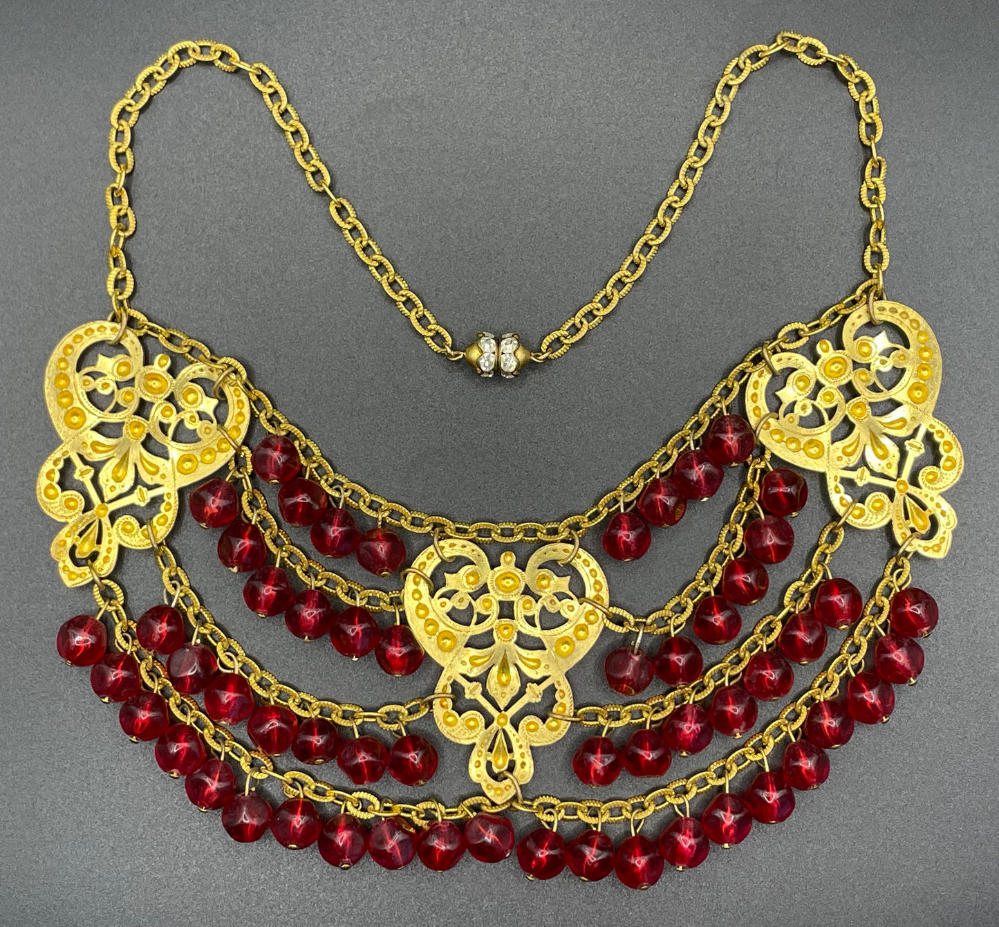 Vintage ruby red poured glass beaded festoon fringe necklace with gold tone filigree panels, French or Czech or perhaps Miriam Haskell style
