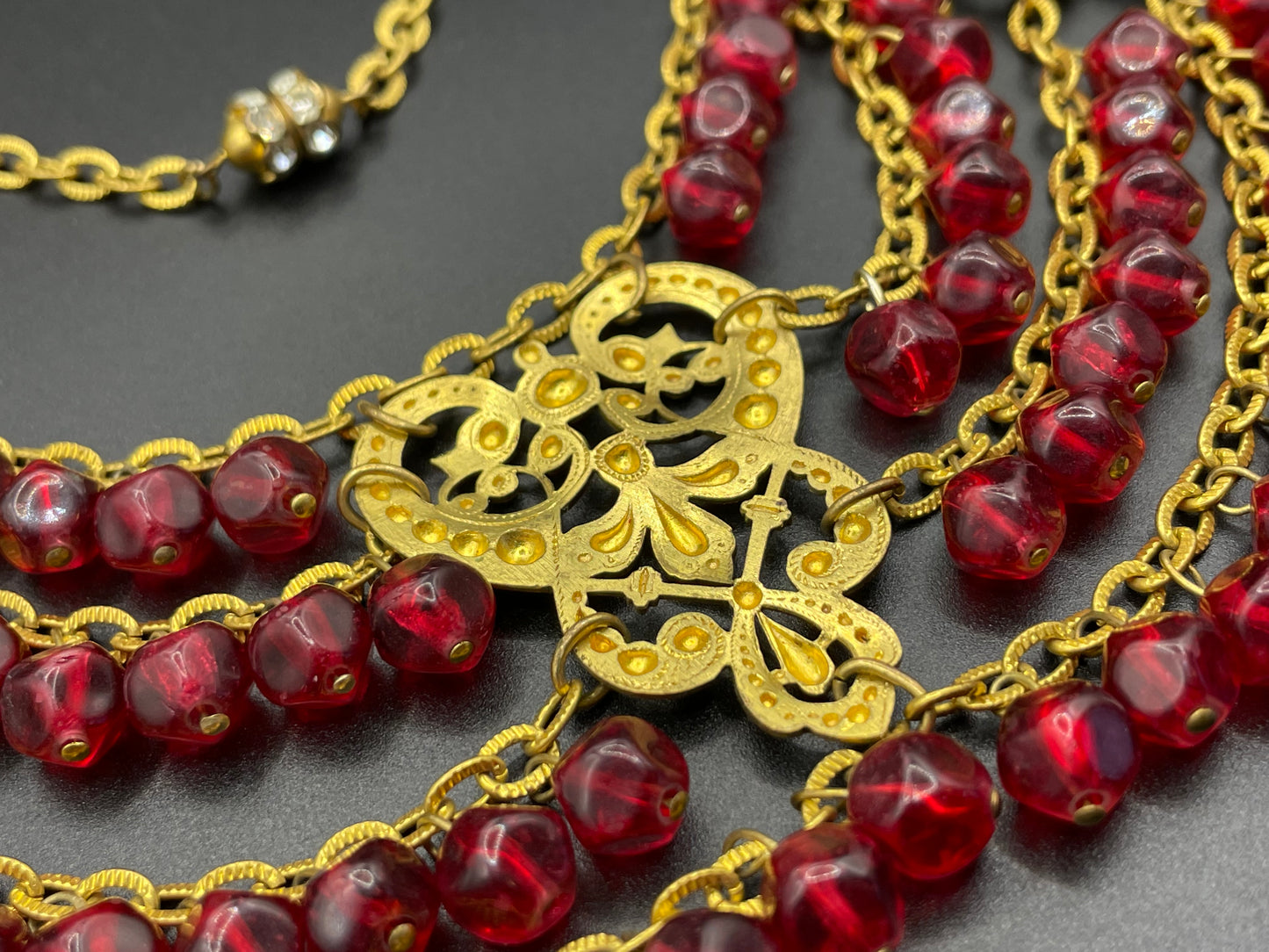 Vintage ruby red poured glass beaded festoon fringe necklace with gold tone filigree panels, French or Czech or perhaps Miriam Haskell style
