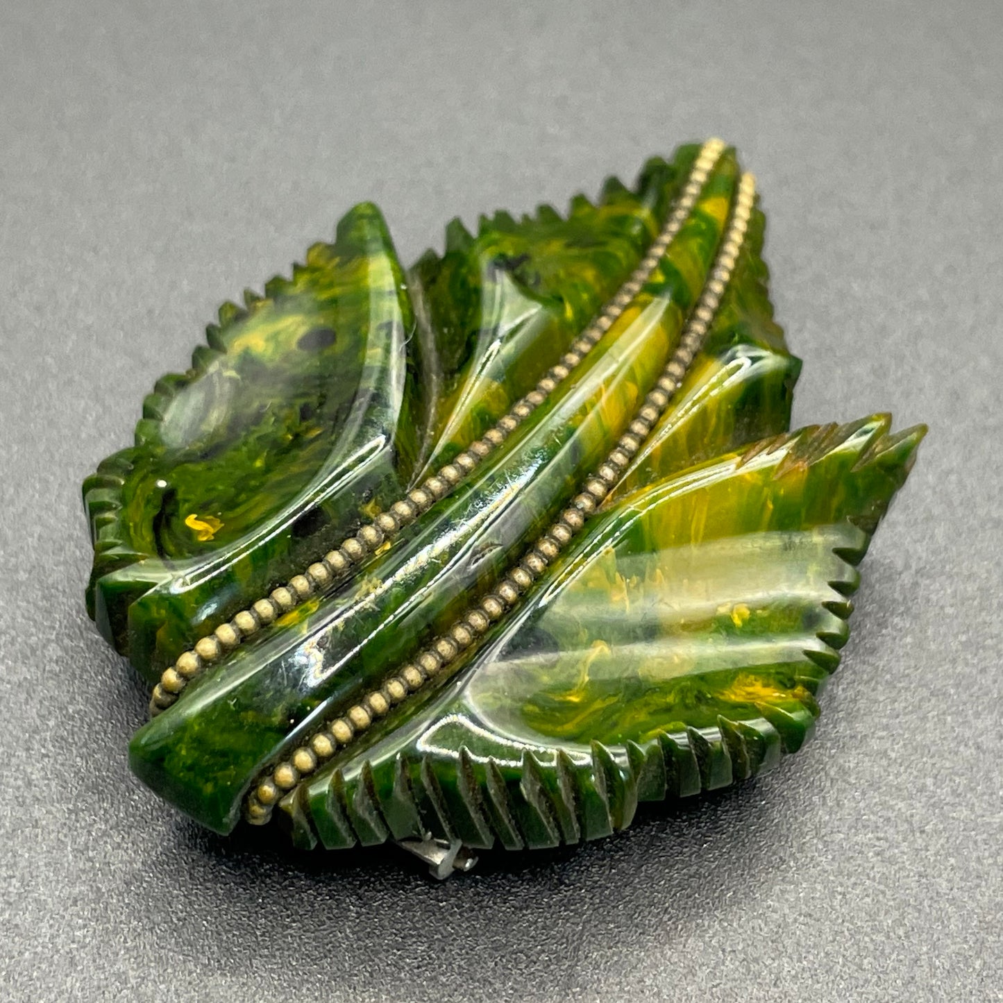 Vintage green marbled Bakelite (verified) and gold tone leaf design dress clip - with slim chain included to double as a pendant