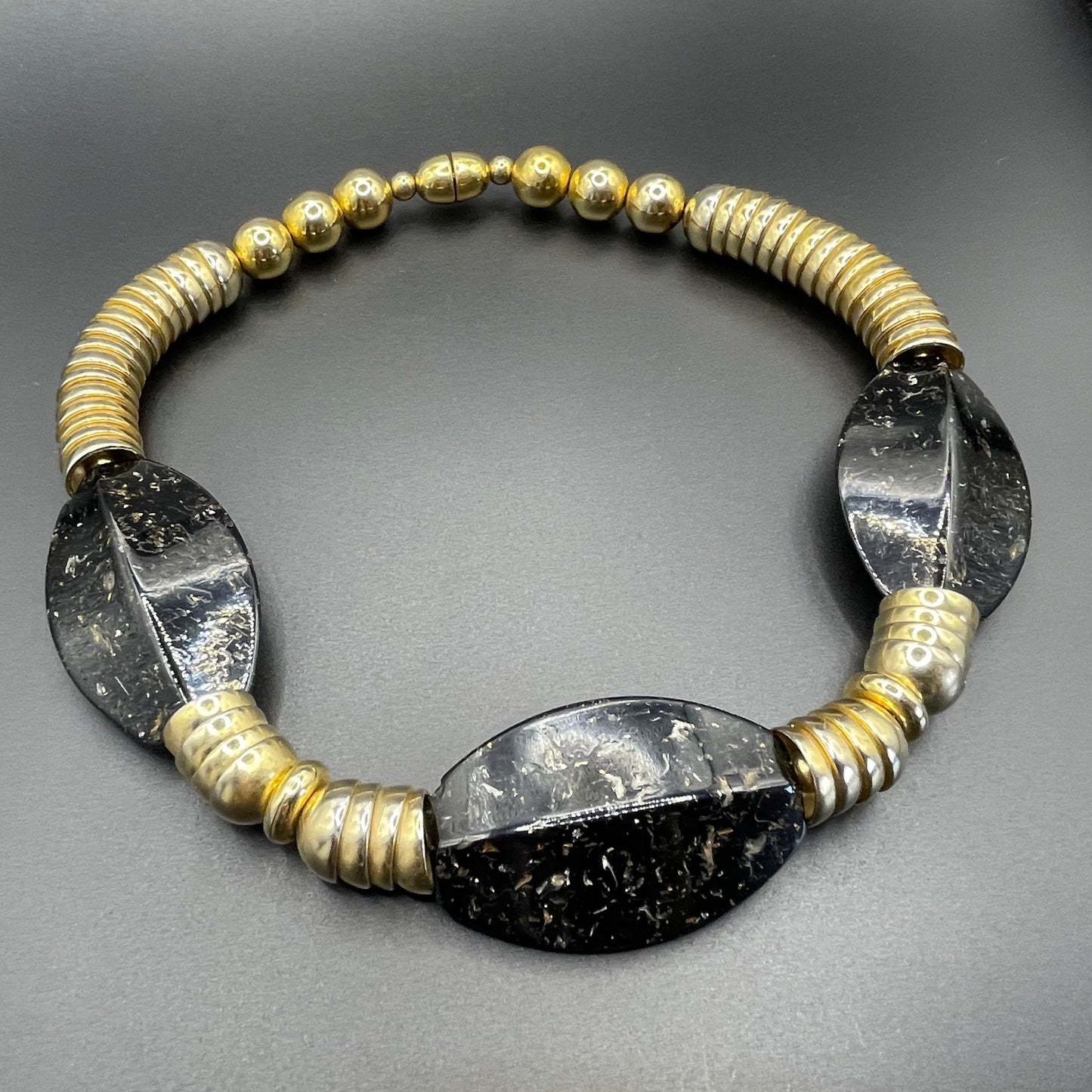 Vintage Jakob Bengel Art Deco 1930s machine age collar necklace with gold tone stacked cup beads and huge black, sparkly galalith beads
