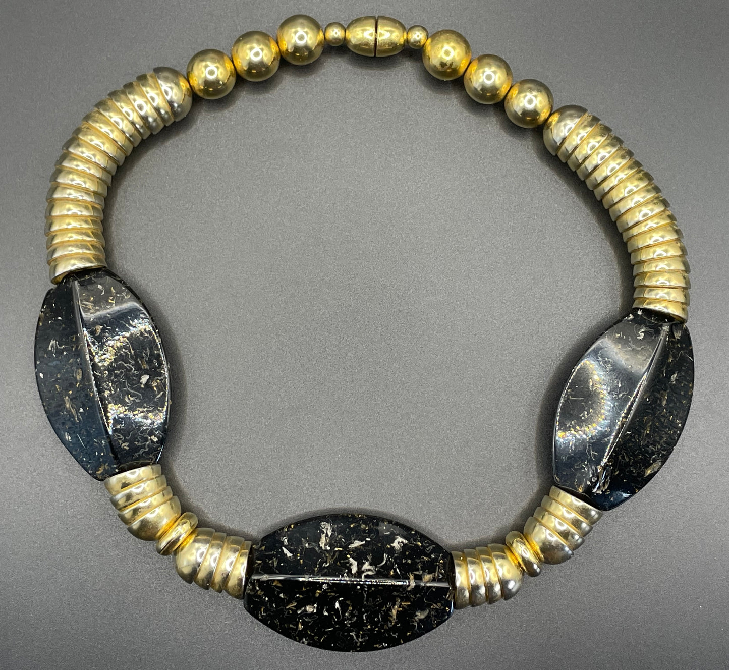Vintage Jakob Bengel Art Deco 1930s machine age collar necklace with gold tone stacked cup beads and huge black, sparkly galalith beads