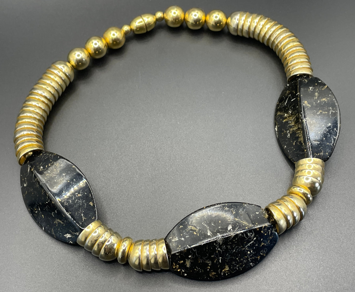Vintage Jakob Bengel Art Deco 1930s machine age collar necklace with gold tone stacked cup beads and huge black, sparkly galalith beads