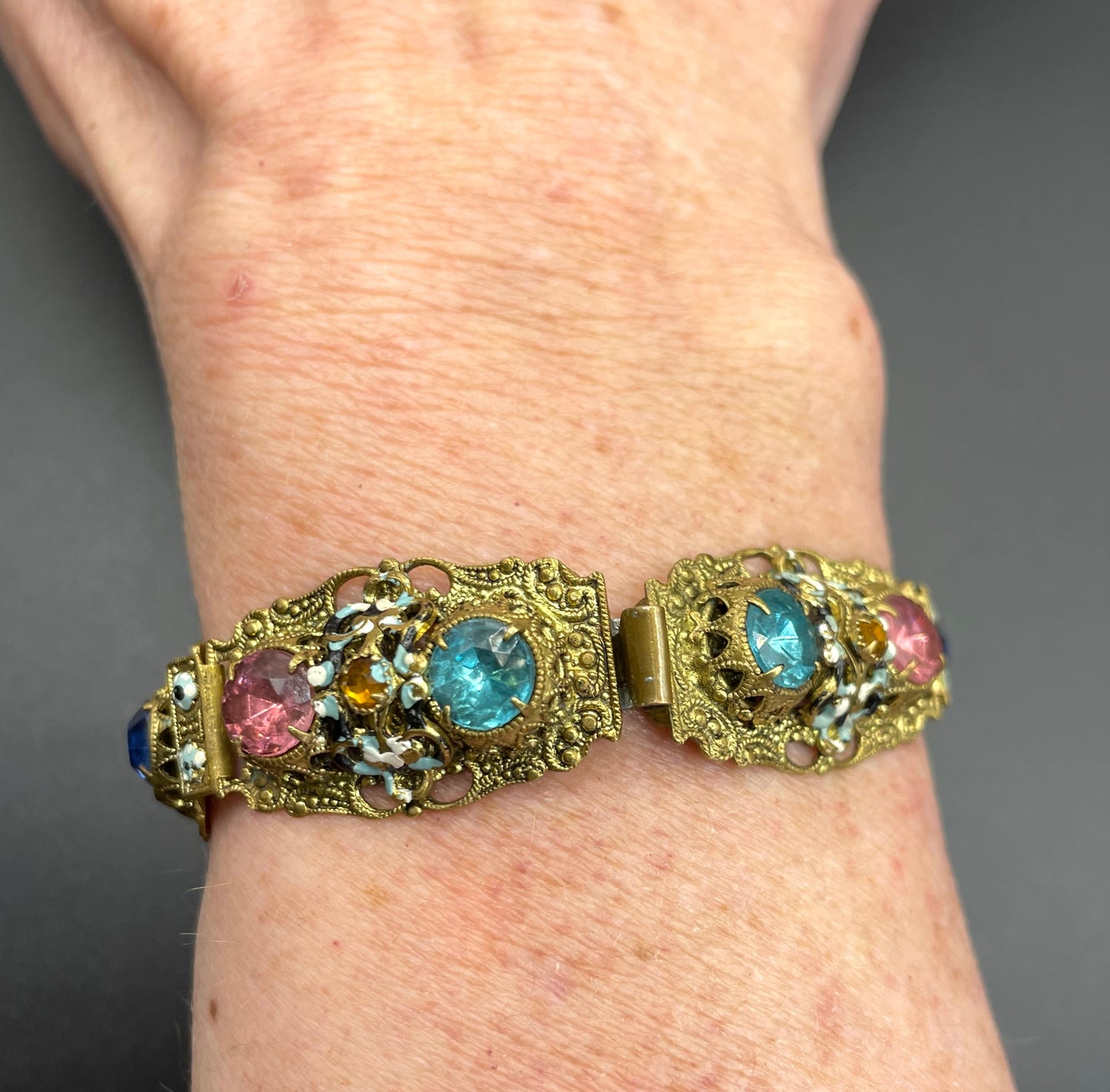 Vintage Art Deco Czech gold tone filigree, multicoloured glass rhinestone and cold painted enamel panel bracelet, possibly Neiger Brothers