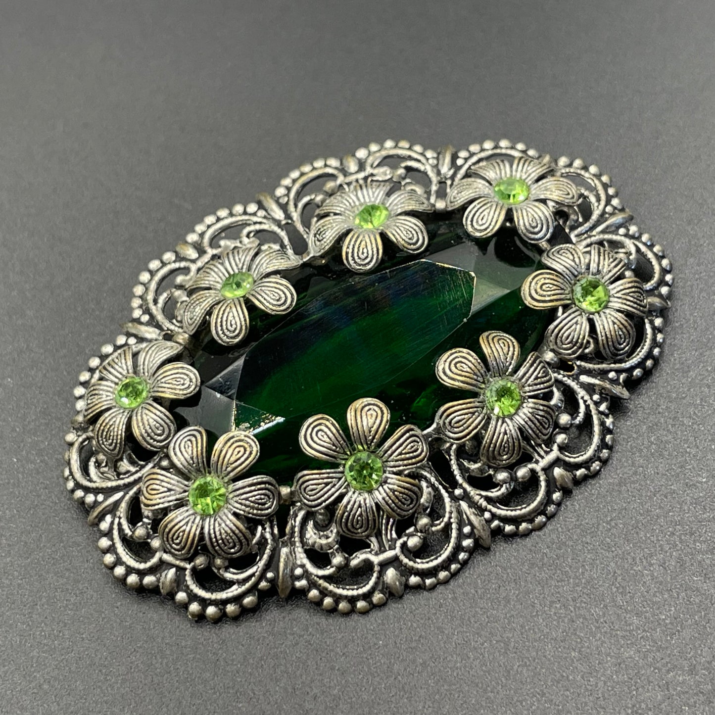 Vintage Art Deco 1930s Czech light & dark green rhinestone brooch with antique silver tone floral filigree - large open backed green crystal
