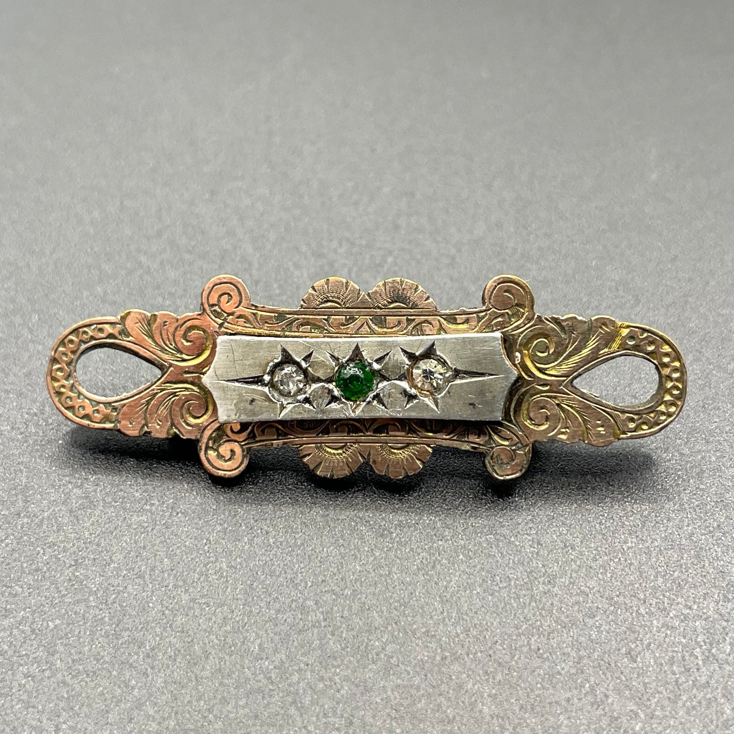 Adorable small antique Victorian gold tone (probably rolled gold) and silver fronted brooch, with clear and green (untested) stones, stamped
