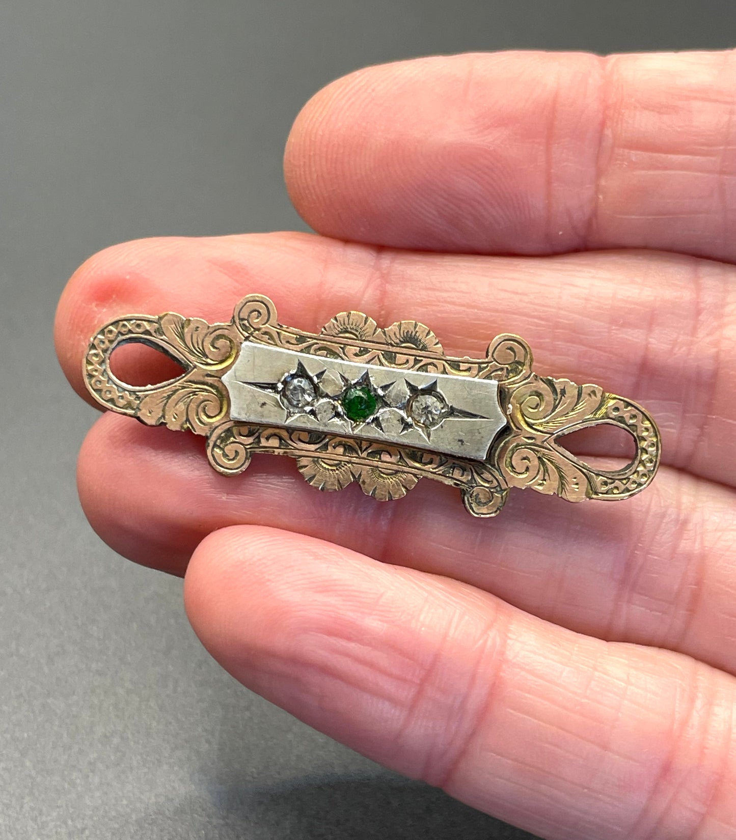 Adorable small antique Victorian gold tone (probably rolled gold) and silver fronted brooch, with clear and green (untested) stones, stamped