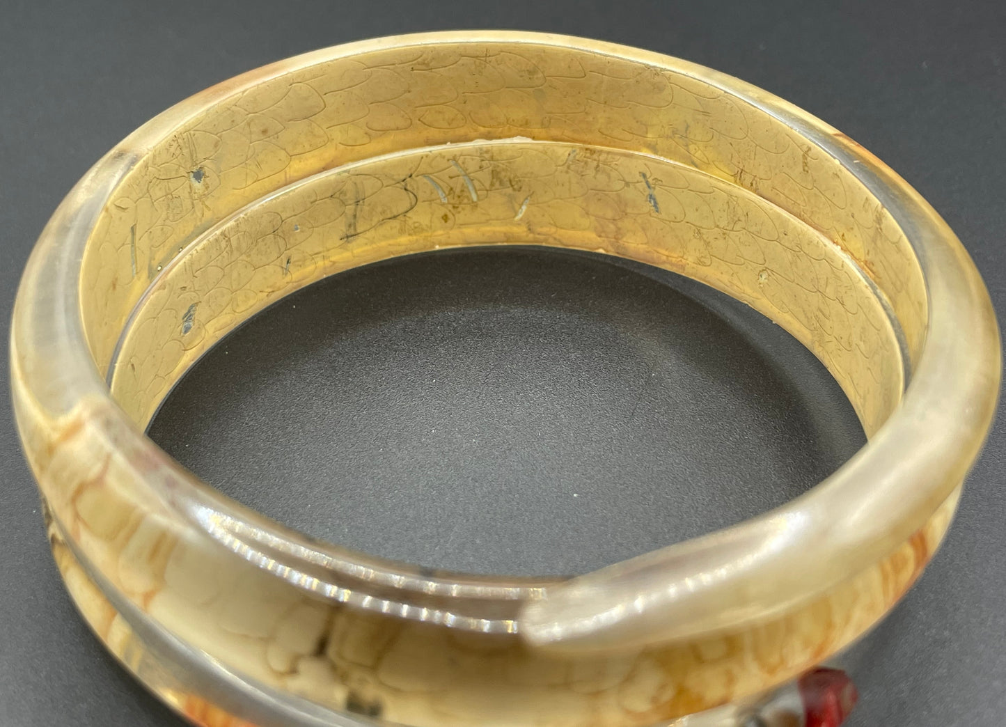 Vintage Art Deco 1920s to 1930s reverse painted, clear celluloid spiral snake bangle bracelet, clear rhinestone eyes