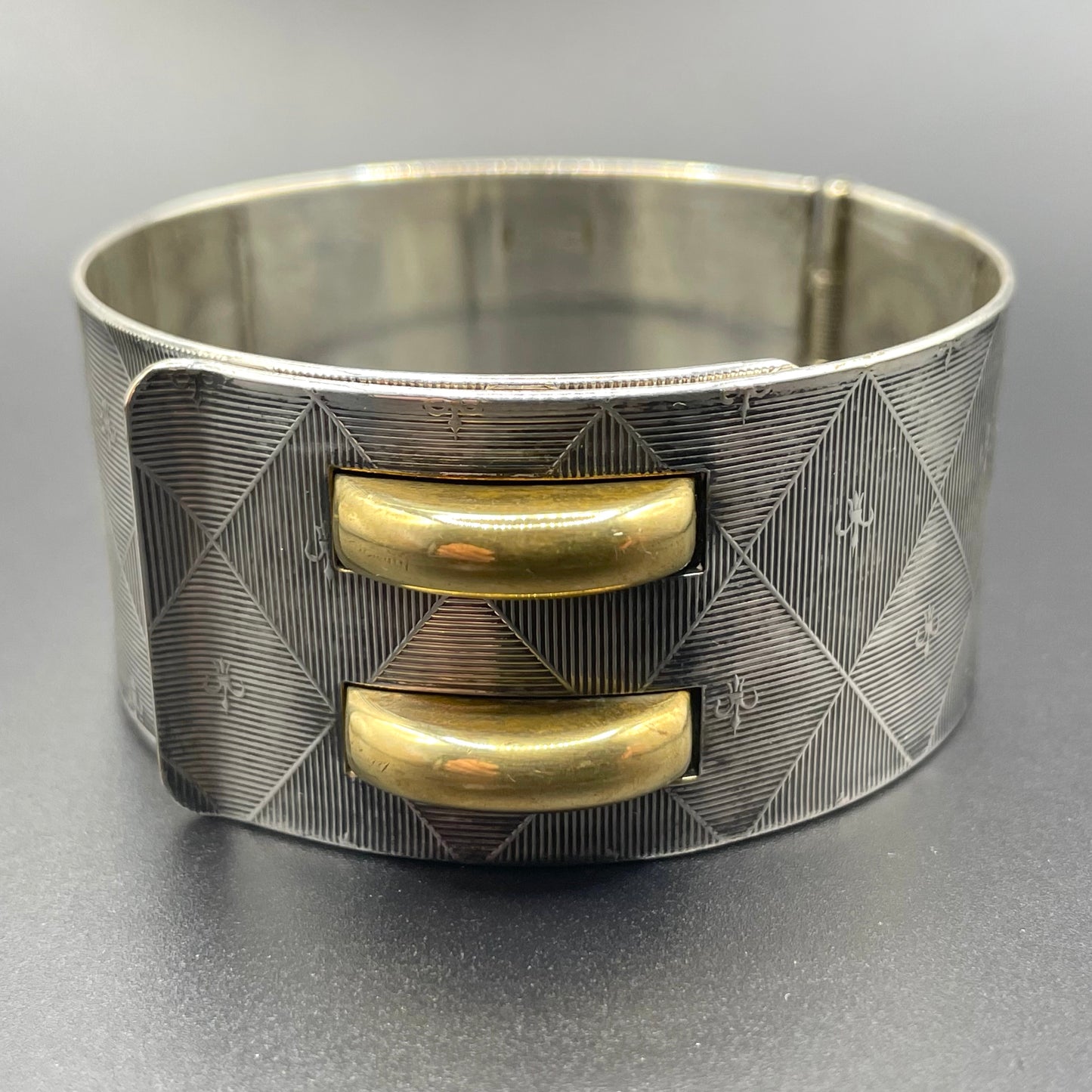 Vintage signed Kigu Art Deco engine turned machine age gold and silver tone wide bangle bracelet hinged cuff, fleur de lys Bauhaus design