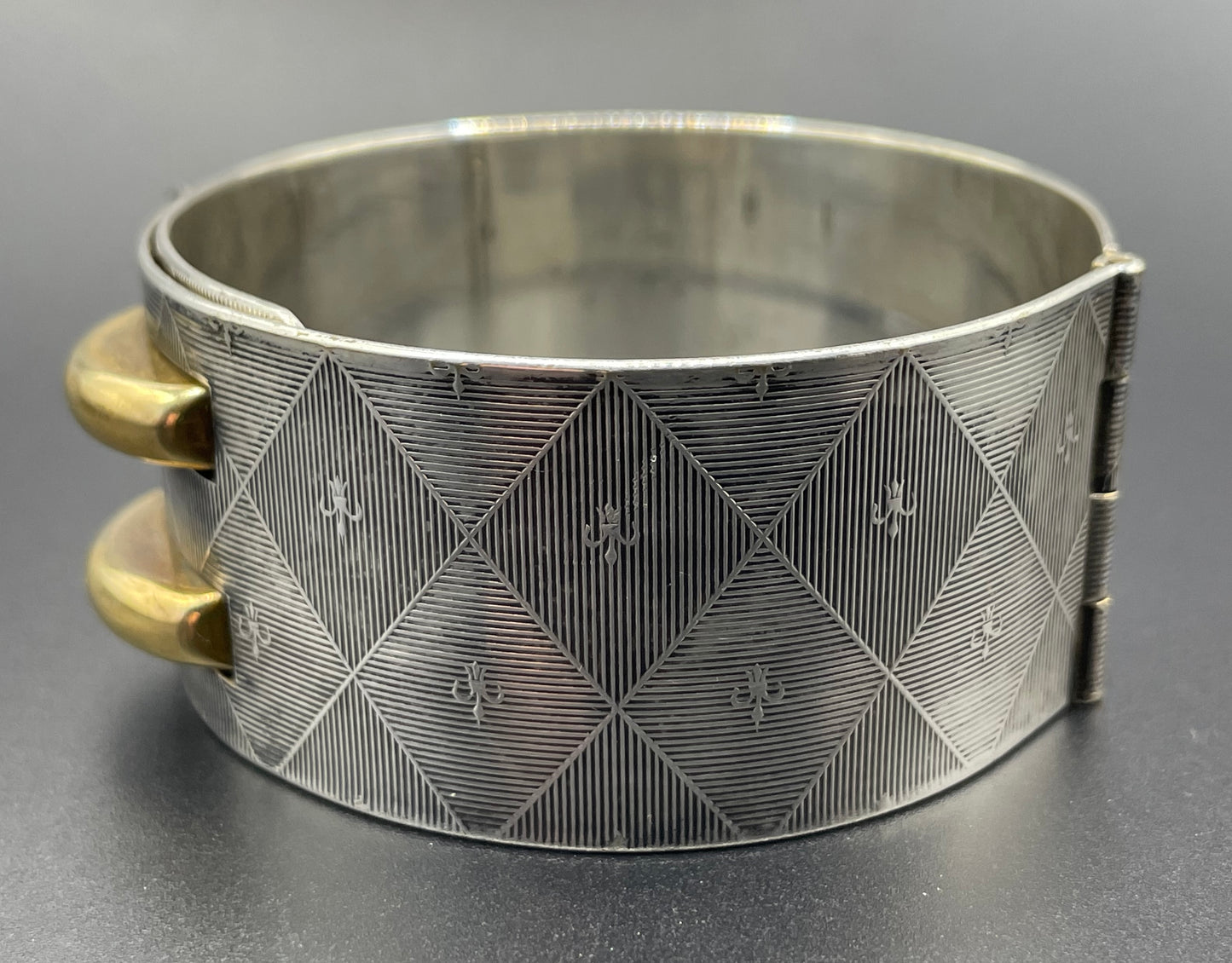 Vintage signed Kigu Art Deco engine turned machine age gold and silver tone wide bangle bracelet hinged cuff, fleur de lys Bauhaus design